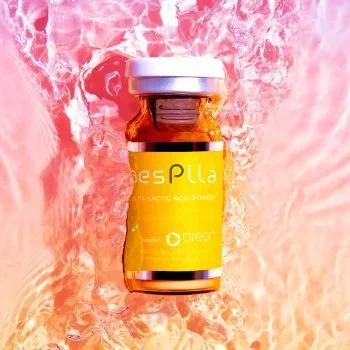 A small brown glass vial with a yellow label that says 'esPlla' and 'Oregon,' surrounded by splashing water and pink ice.