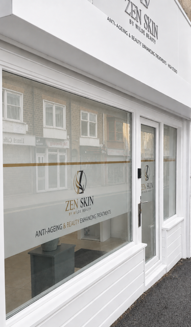 Storefront window with signage for Zen Skin by Wild E, promoting anti-aging and beauty treatments.