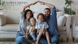 A young couple with two children using their hands to show their home