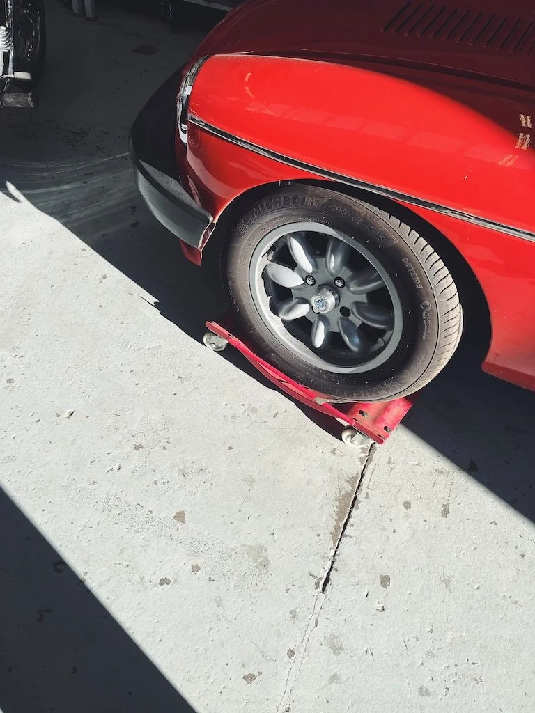 the wing of a red classic car