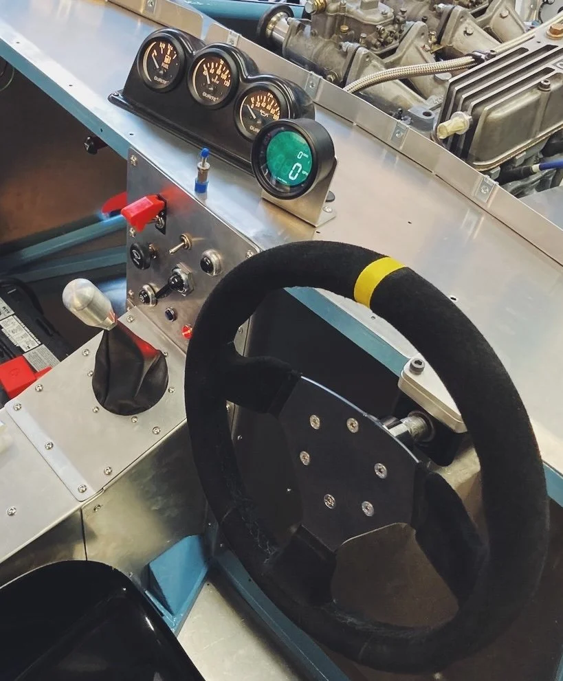 the steering wheel and dashboard of a historic race car