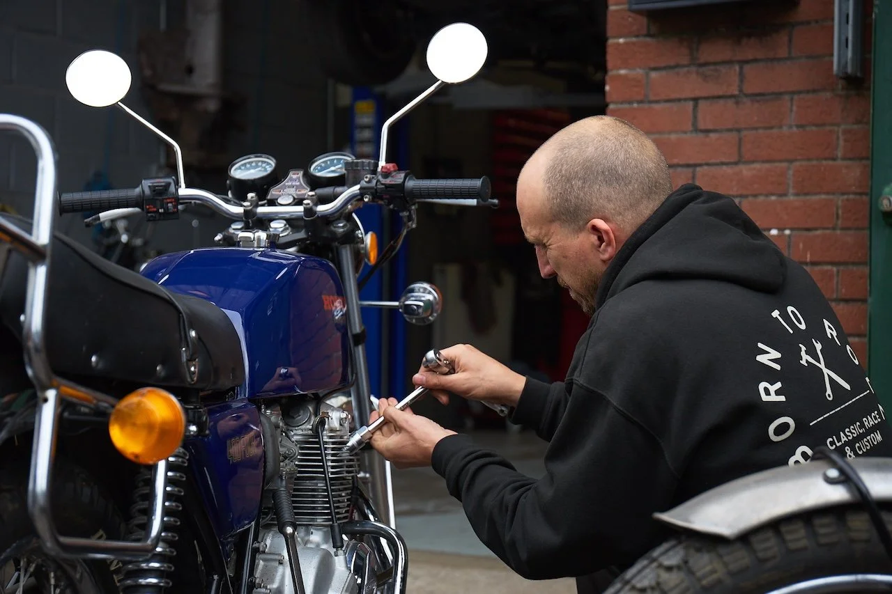 classic honda motorcycle being repaired in a workshop in bristol