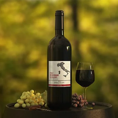 Bottle of Italian wine on a table with a glass of red wine, surrounded by green and red grapes, outdoors.