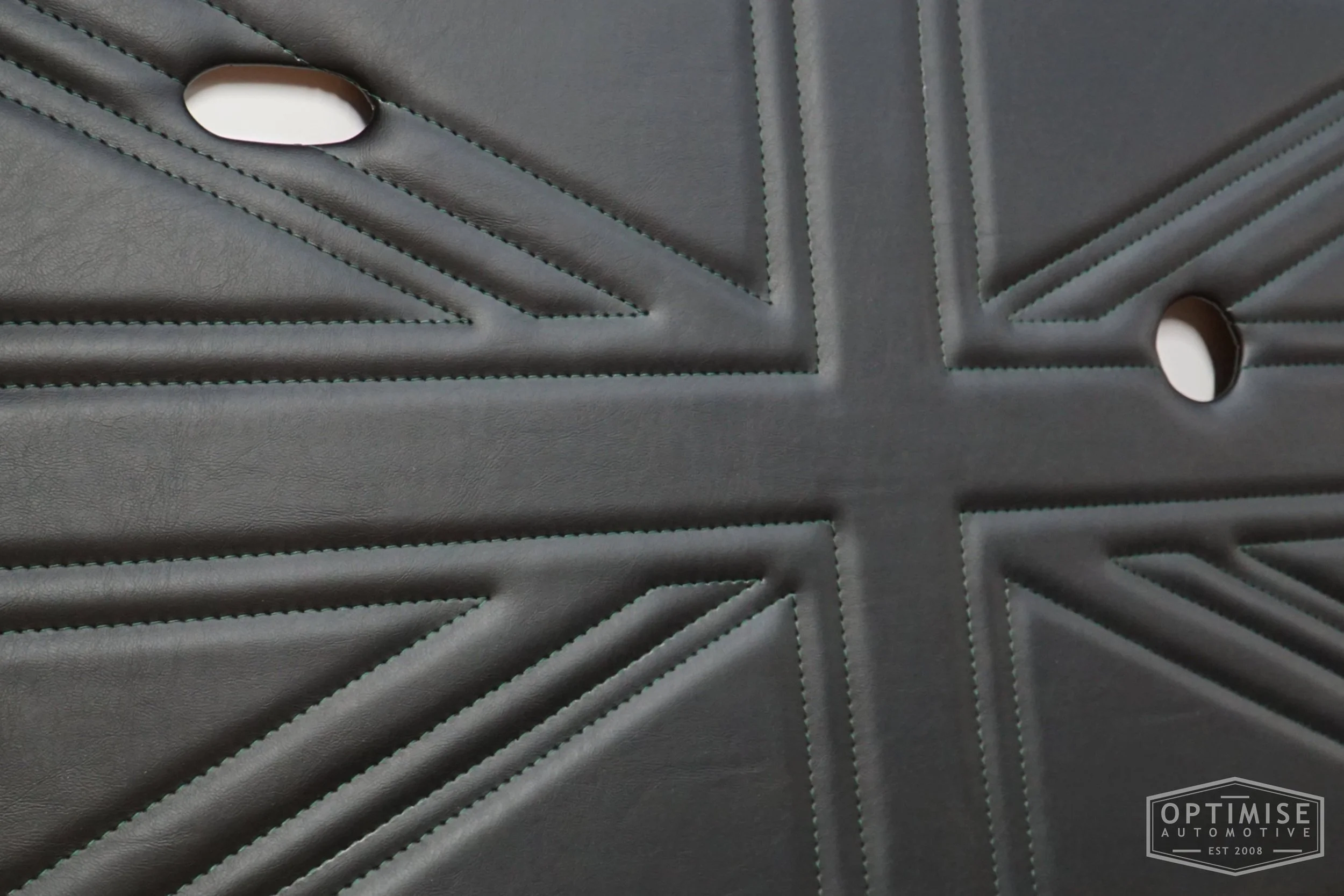 Classic Mini Union Jack door cards, trimmed in black with dark green stitching.