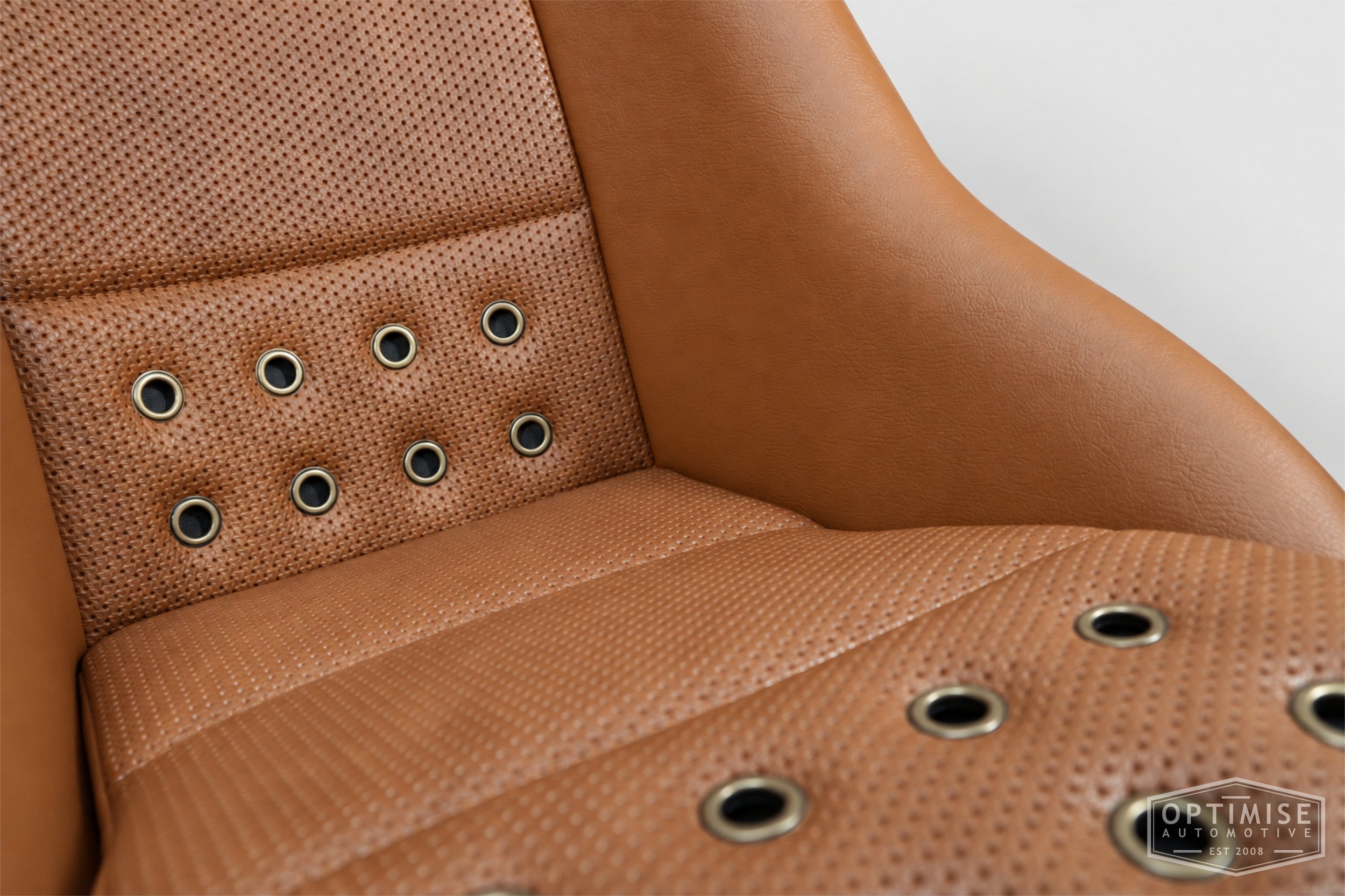 Classic Mini seat retrims featuring Cobra Classic front seats, trimmed in tan leatherette and tan basketweave  with bronze eyelets.