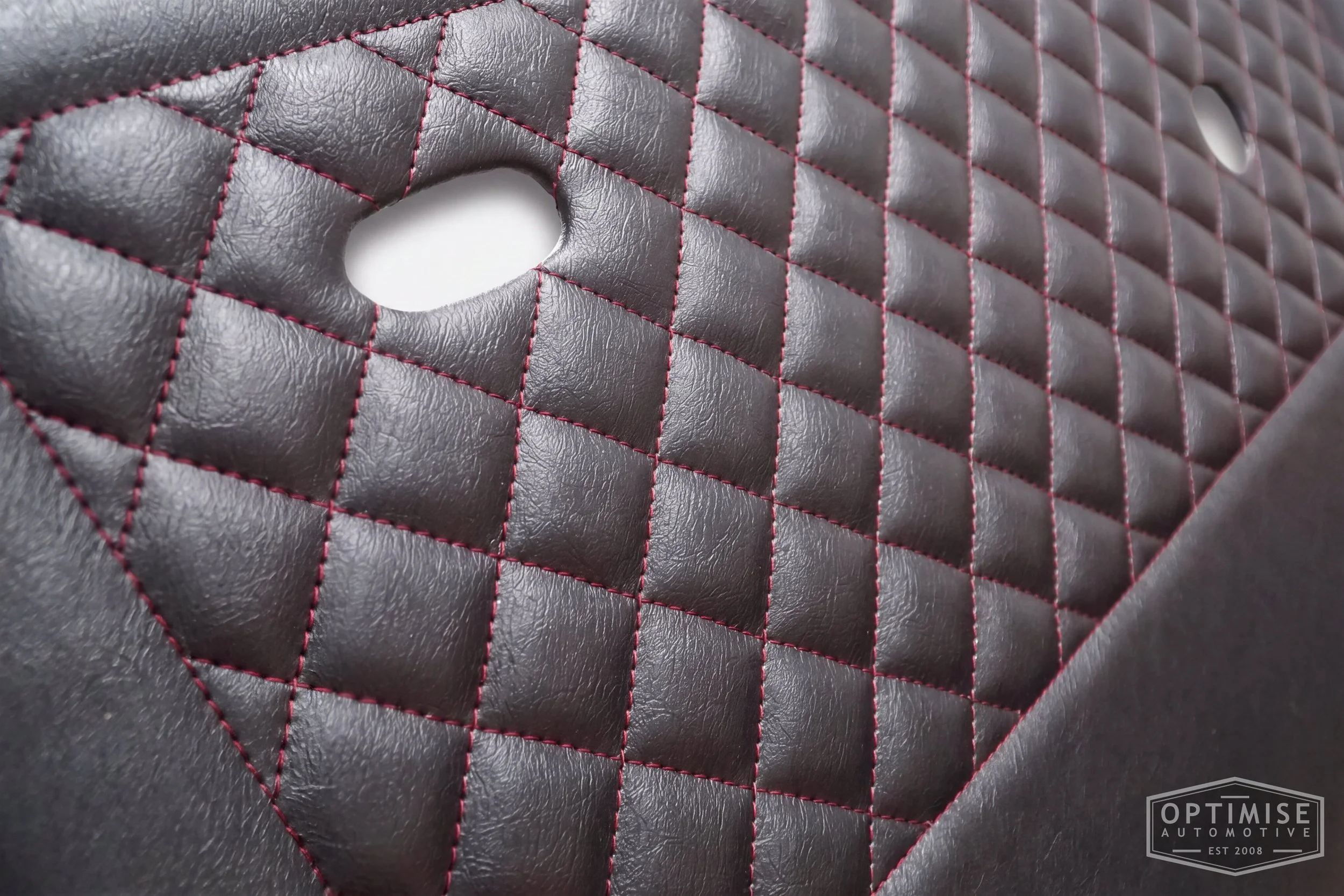 Classic Mini door cards, trimmed in black vinyl leatherette with a dark red diamond stitched featured panel.