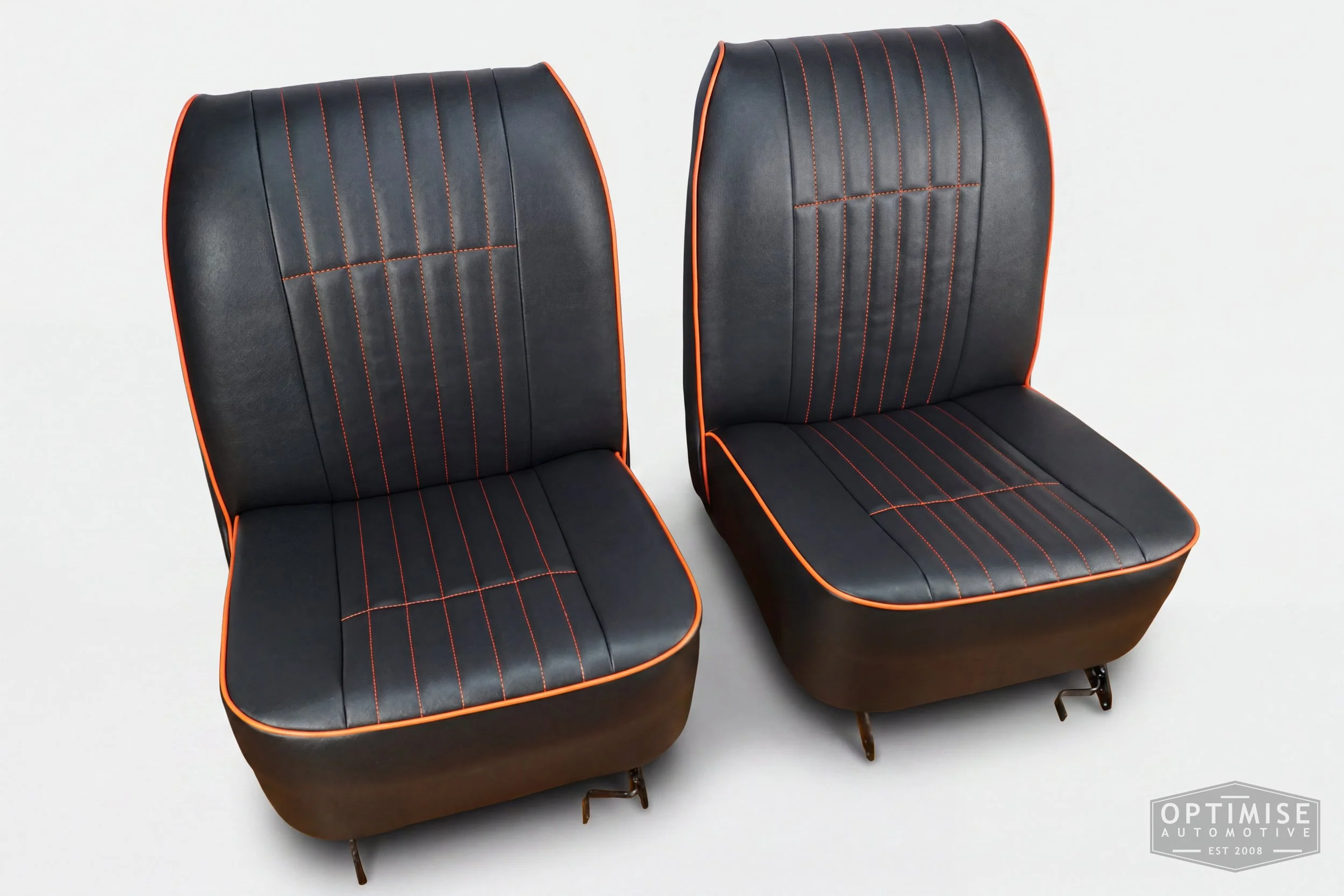 Classic Mini non-reclining seat retrims, trimmed in black leatherette with orange piping and orange stitching.