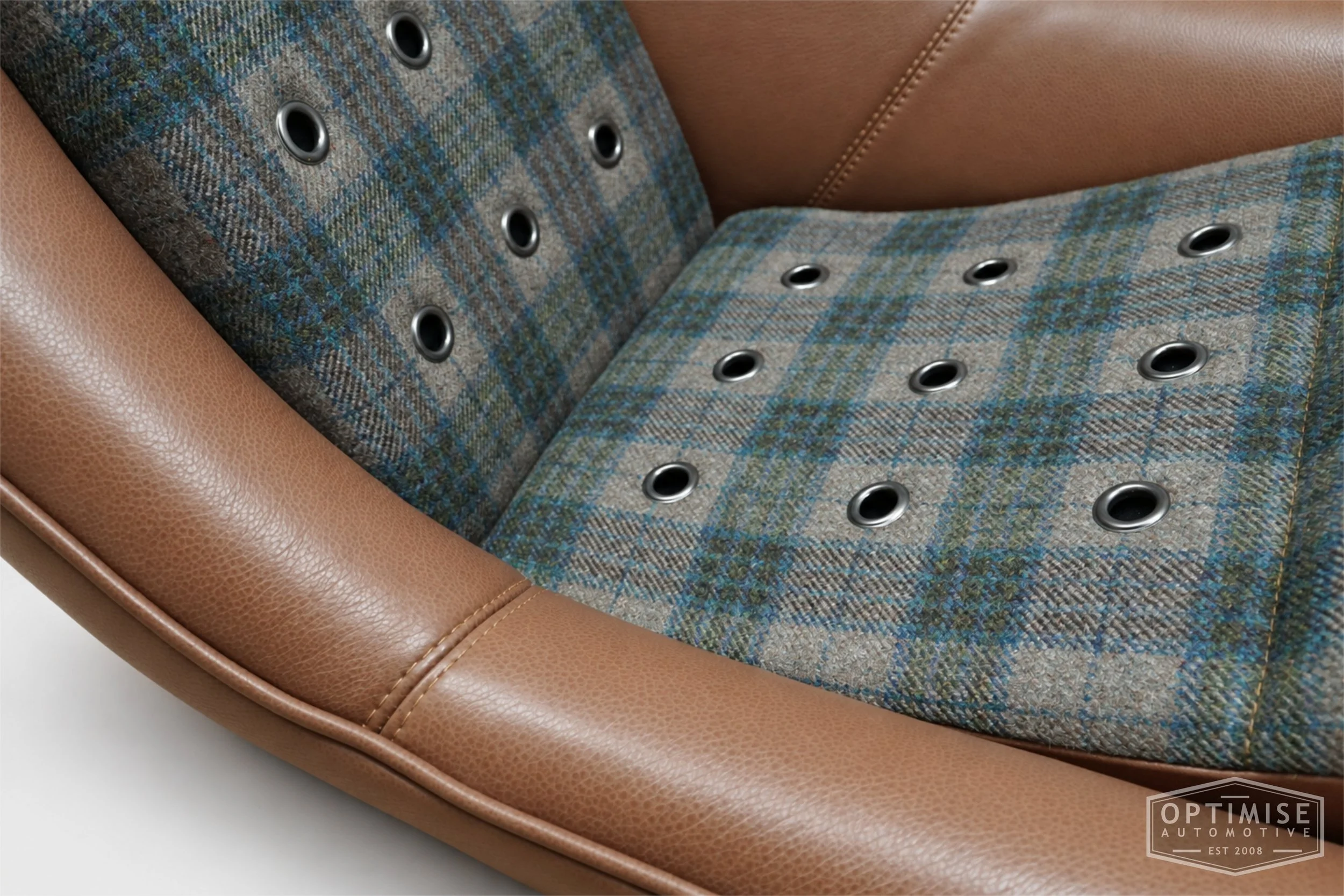 Classic Mini seat retrims featuring Cobra Classic RS front seats and a matching MPi rear seat, trimmed in Norfolk Check Tweed 0834 and Crest Cambridge lark leather, with gunmetal eyelets.