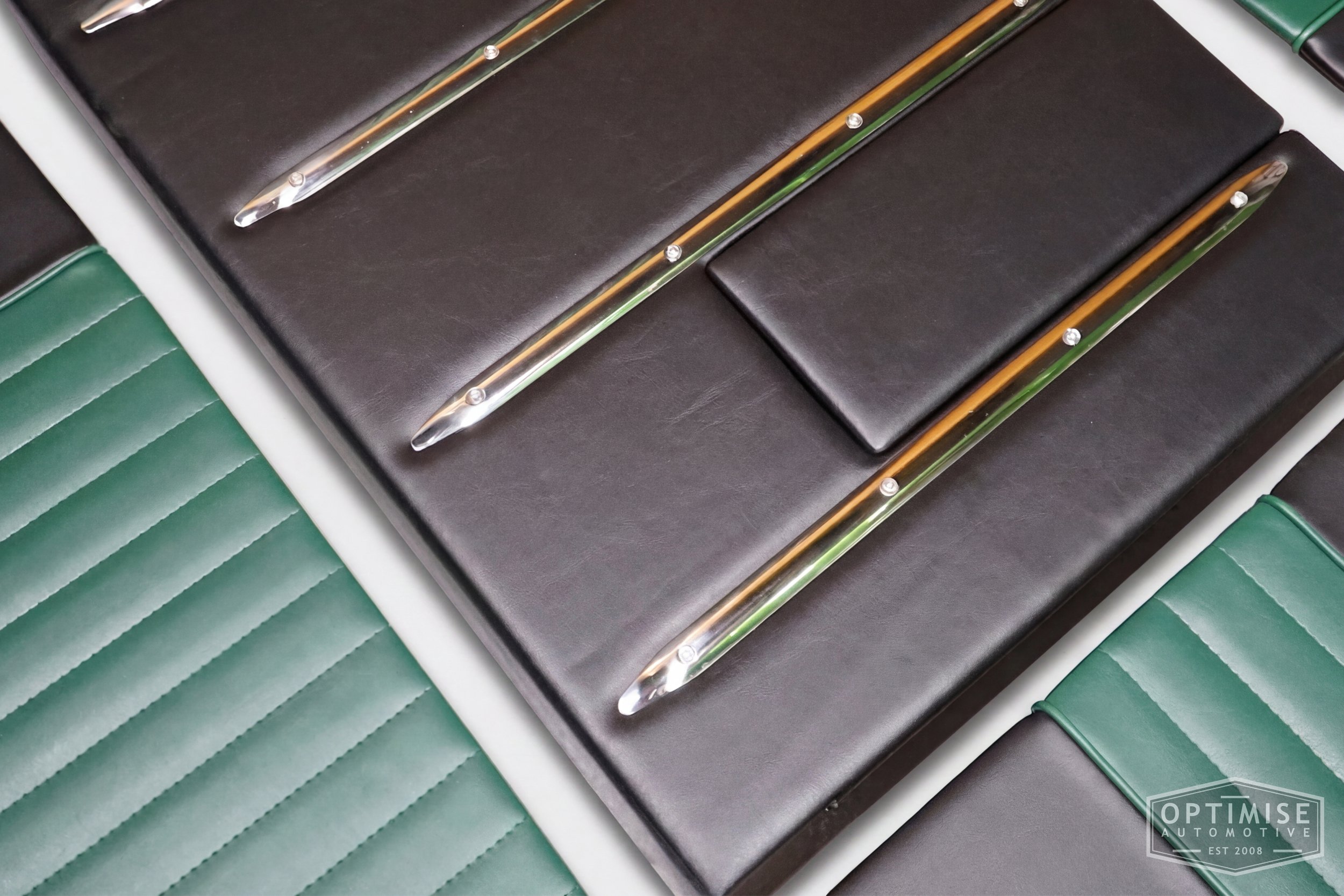 Classic Mini leatherette boot lining kit, trimmed in black and dark green leatherette with dark green piping and dark green stitching.