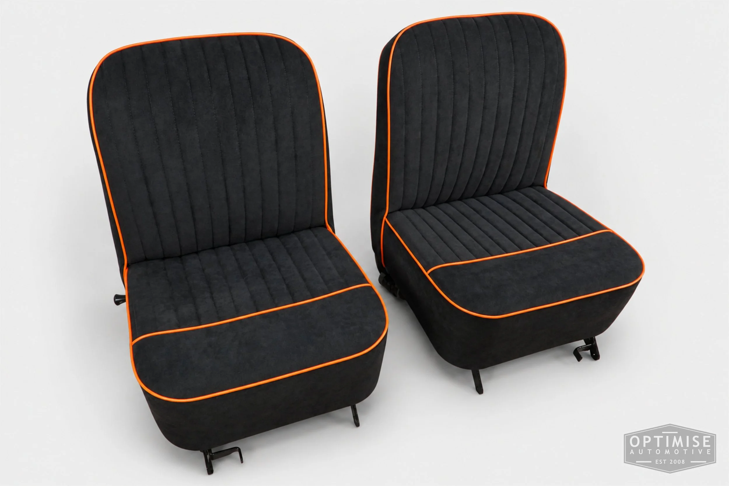 Classic Mini Van seat retrims featuring original non-reclining front seats, trimmed in black Alcantara with orange piping.