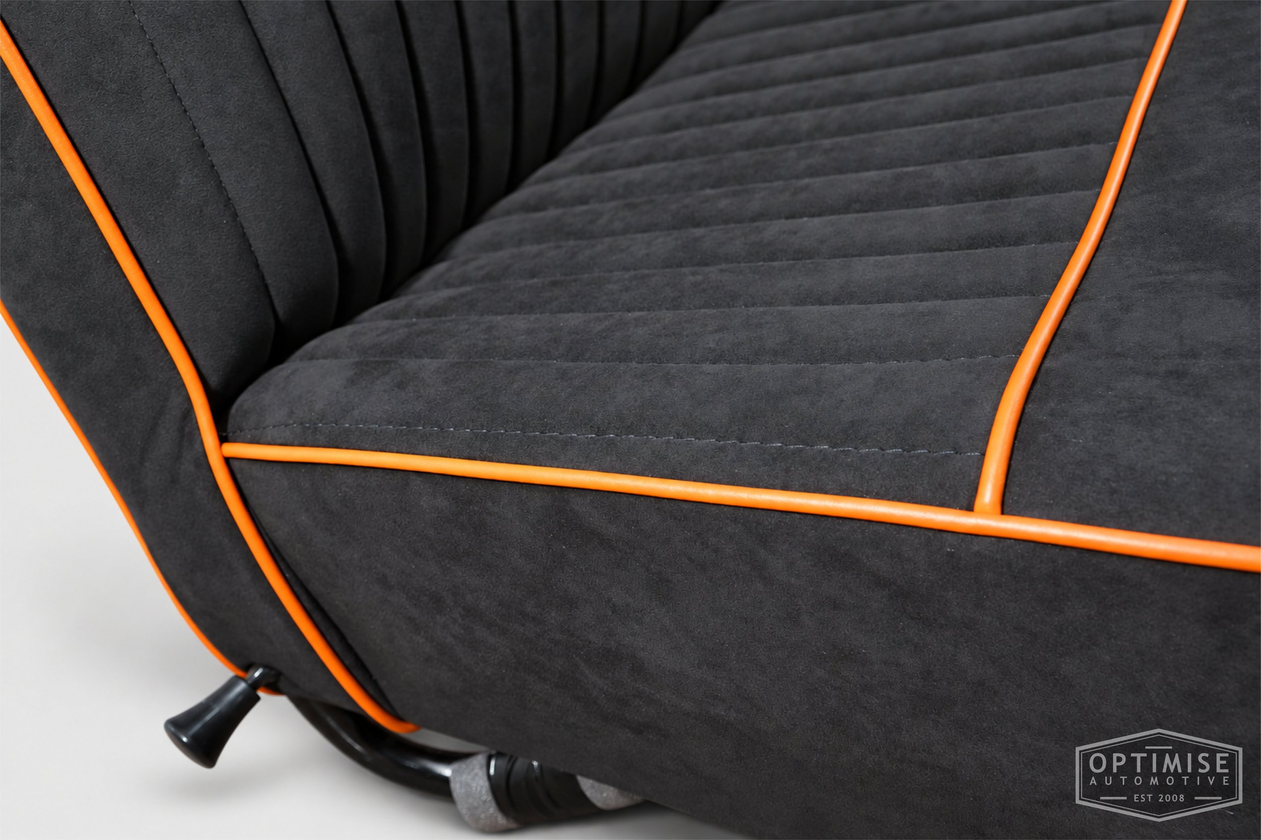 Classic Mini Van seat retrims featuring original non-reclining front seats, trimmed in black Alcantara with orange piping.