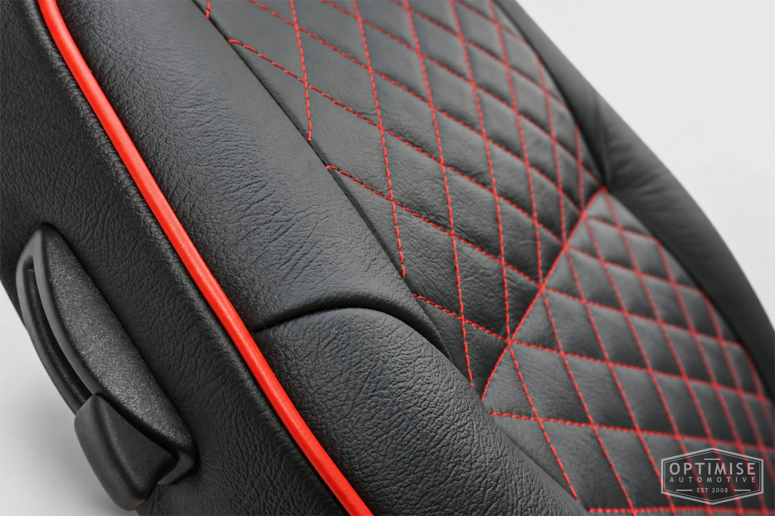 Classic Mini seat retrims featuring original MPi front seats and a matching rear seat, trimmed in black auto grain leather with red diamond stitching and piping.