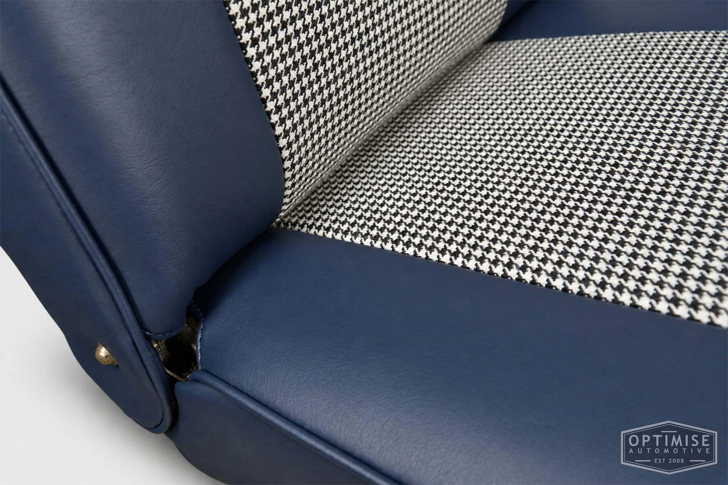Classic Mini seat retrims featuring original reclining front seats and a matching rear seat, trimmed to original specifications in Mayfair black & white houndstooth cloth and midnight blue leatherette.