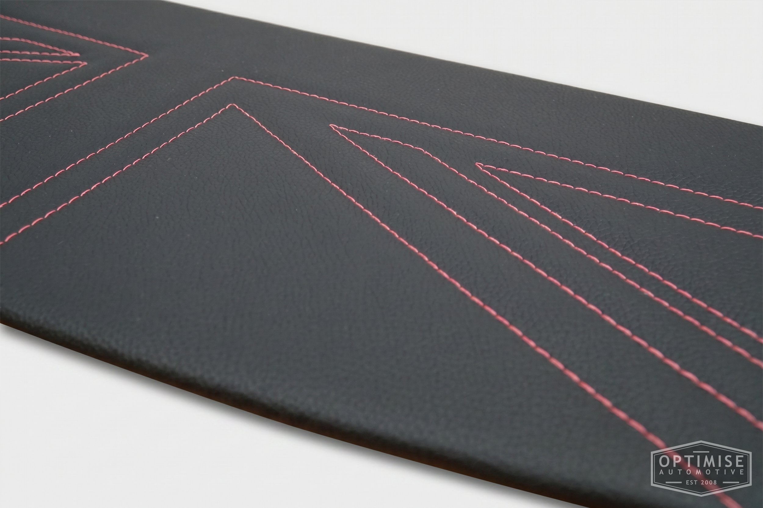 Classic Mini Union Jack parcel shelf board, trimmed in black vinyl leatherette with pink stitching.