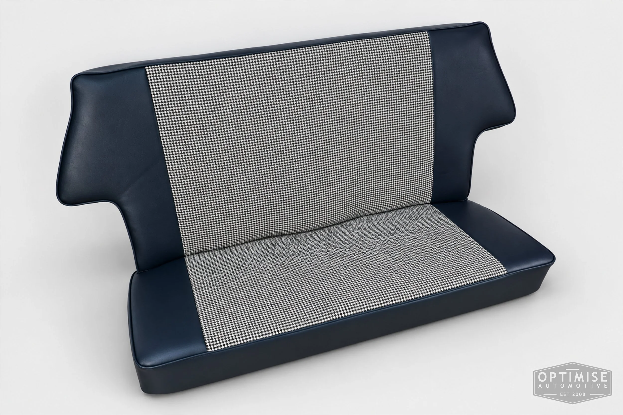 Classic Mini seat retrims featuring original reclining front seats and a matching rear seat, trimmed to original specifications in Mayfair black & white houndstooth cloth and midnight blue leatherette.