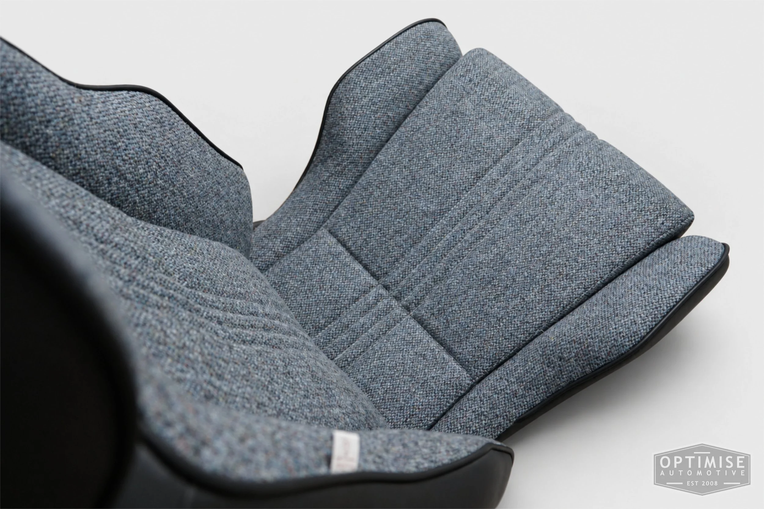 Classic Mini seat retrims featuring Cobra Le Mans front seats and a matching MK6 rear seat, trimmed in black leatherette and Harris Tweed blue Barleycorn BC1.