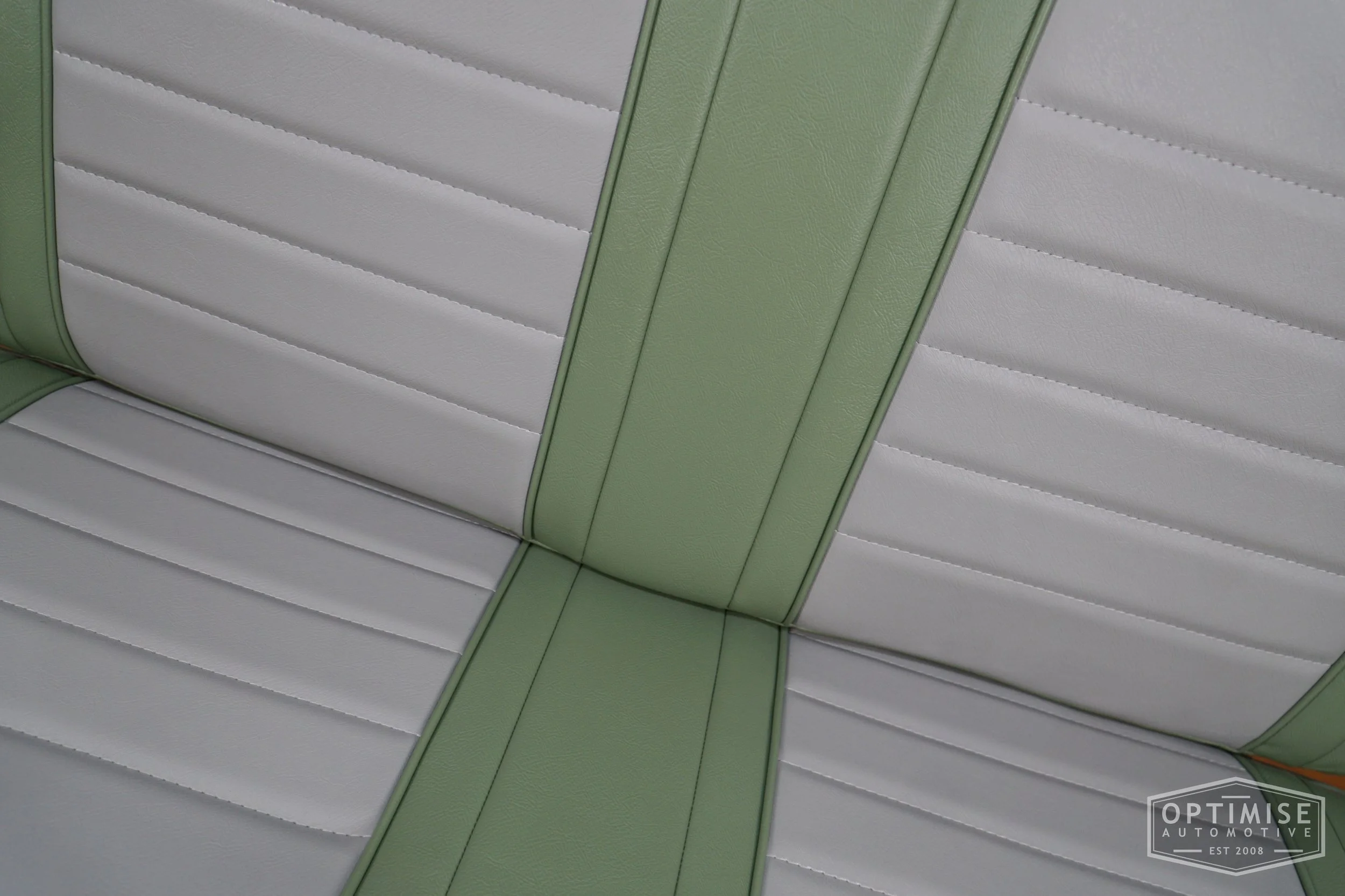 Classic Mini non-reclining seat retrims, trimmed in porcelain green and dove grey vinyl leatherette.