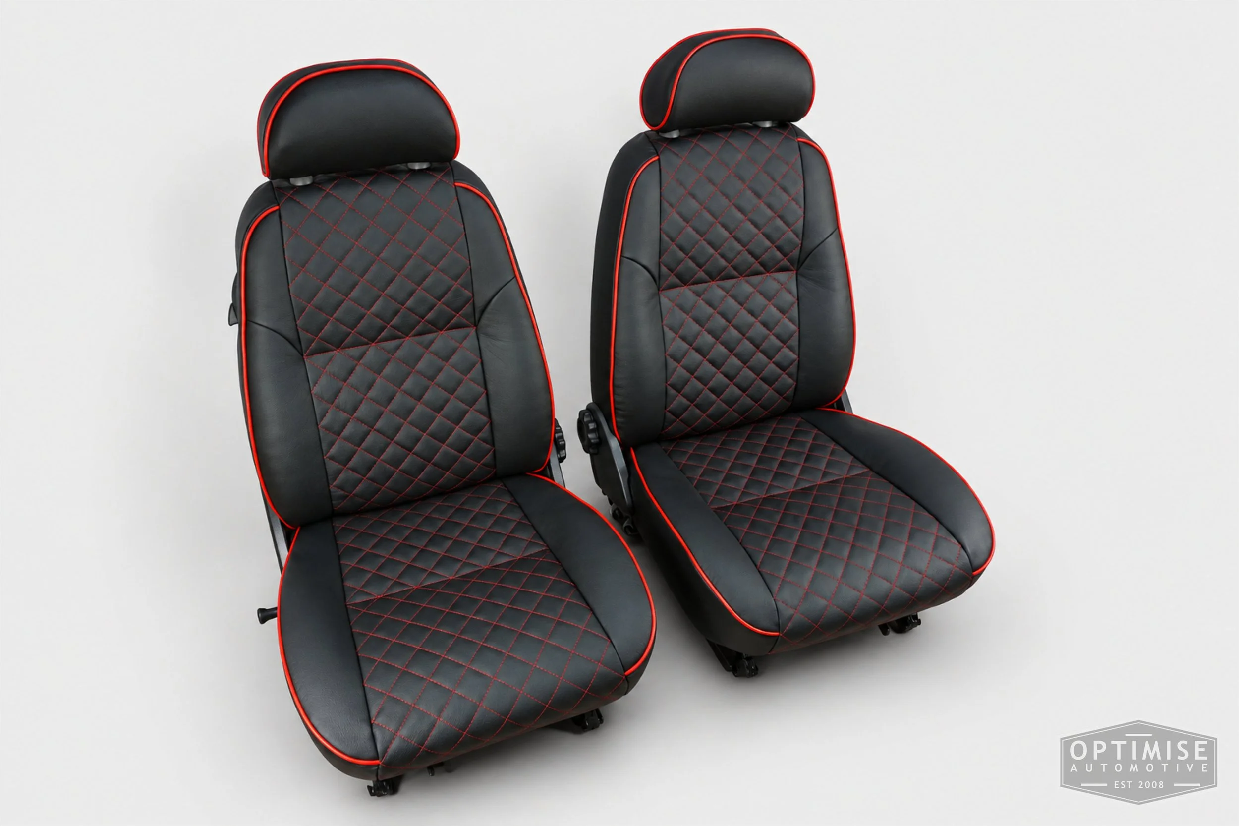 Classic Mini seat retrims featuring original MPi front seats and a matching rear seat, trimmed in black auto grain leather with red diamond stitching and piping.