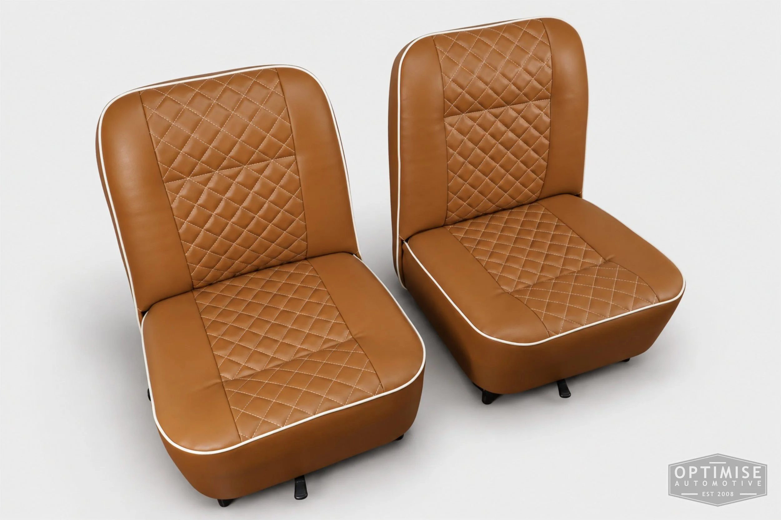 Classic Mini seat retrims featuring original early MK3 vertical-leg non-reclining front seats and a matching early MK3 rear seat, trimmed in tan leatherette with cream diamond stitching and piping.