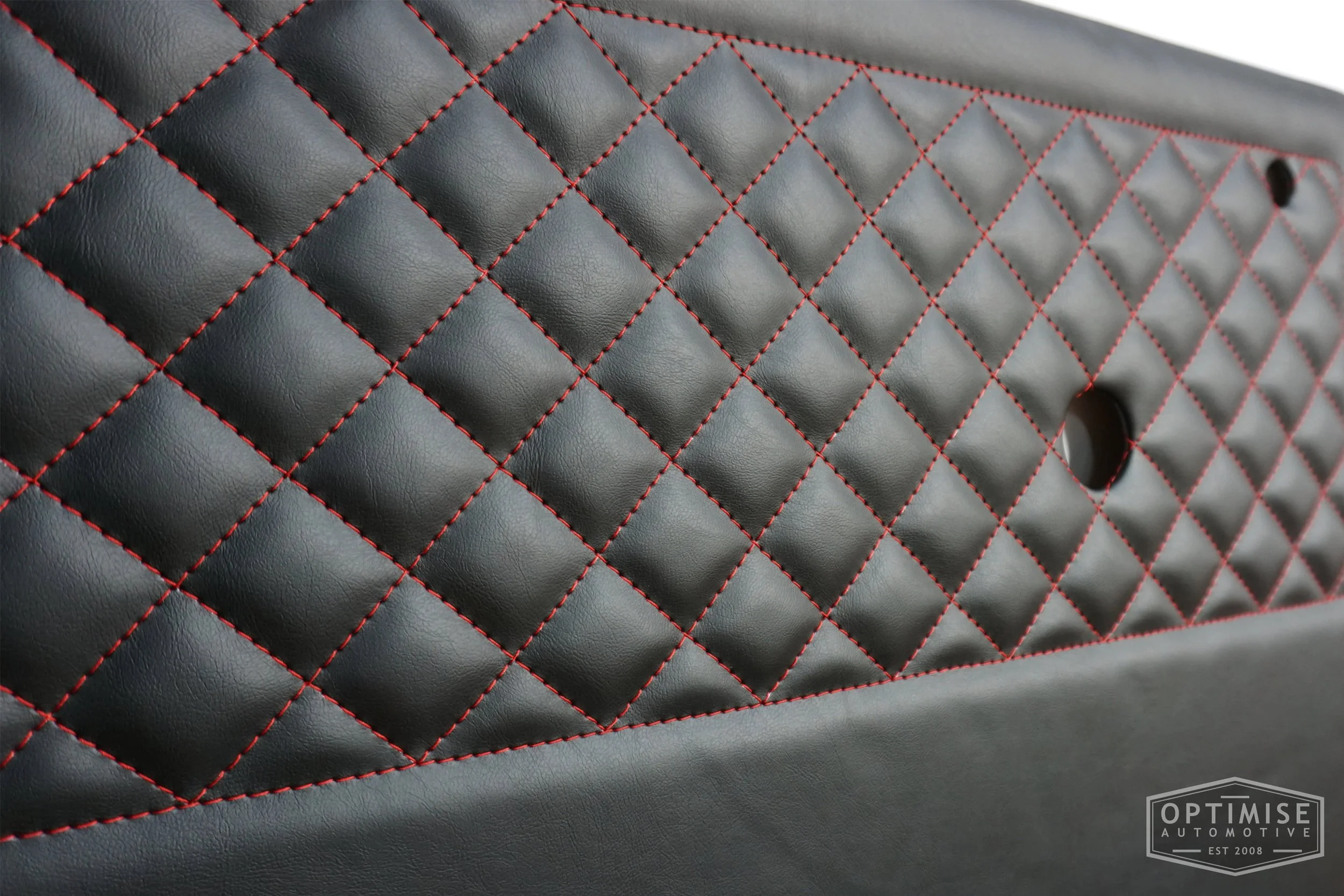 Classic Mini door cards, trimmed in black vinyl leatherette with a red diamond stitched featured panel.