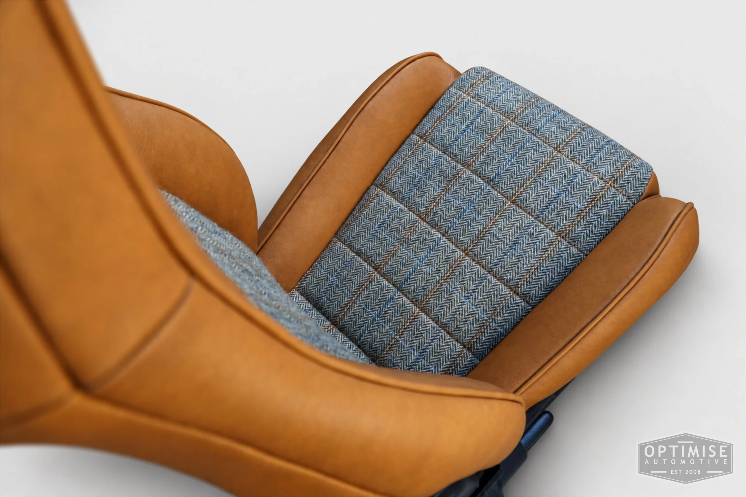 Classic Mini seat retrims featuring Mazda MX-5 front seats and a matching early MK3 rear seat, trimmed in Harris Tweed HB133 and Crest Austen ochre leather.