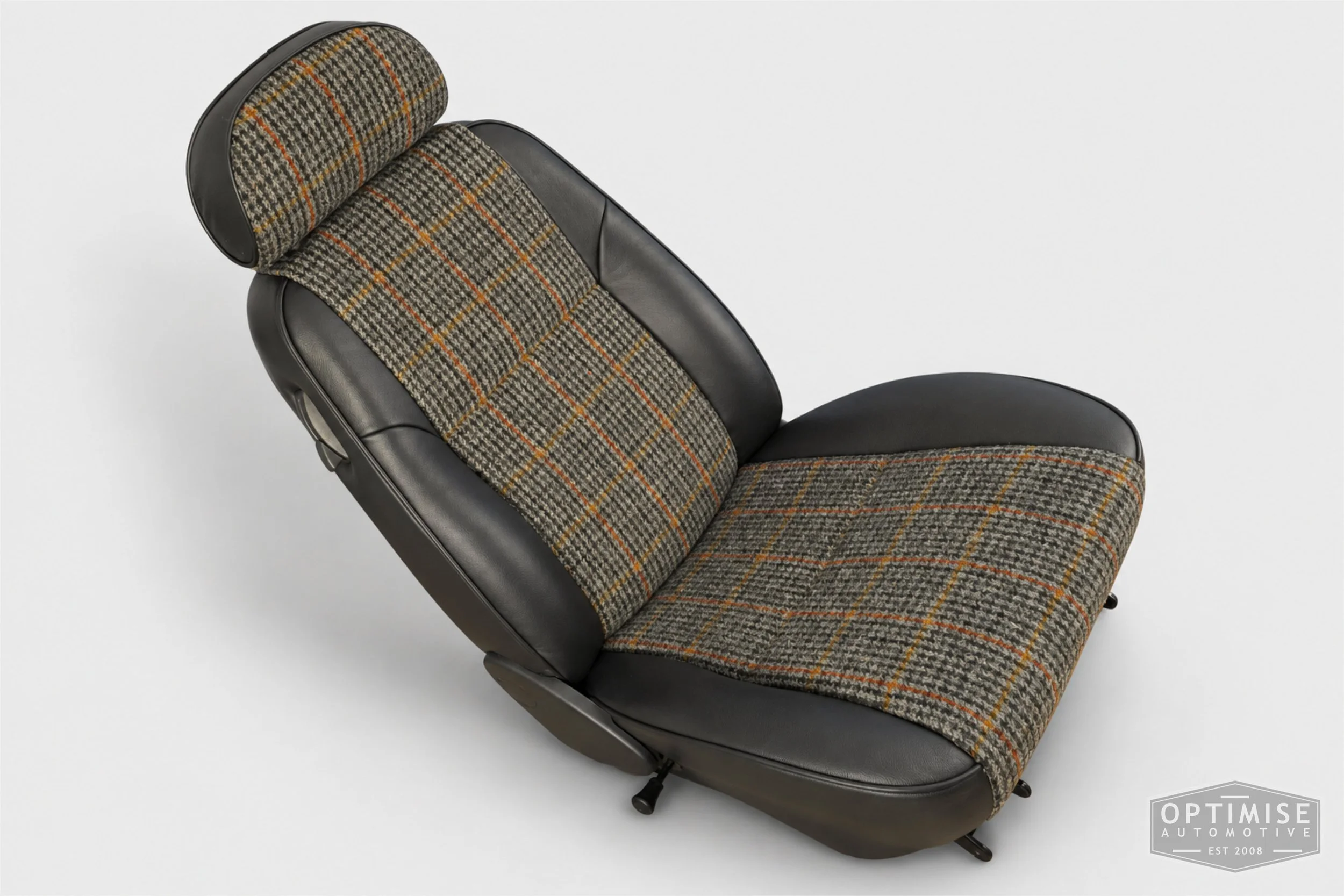 Classic Mini seat retrims featuring original MPi front seats and a matching rear seat, trimmed in Harris Tweed HO57 and black Crest Shelly leather.