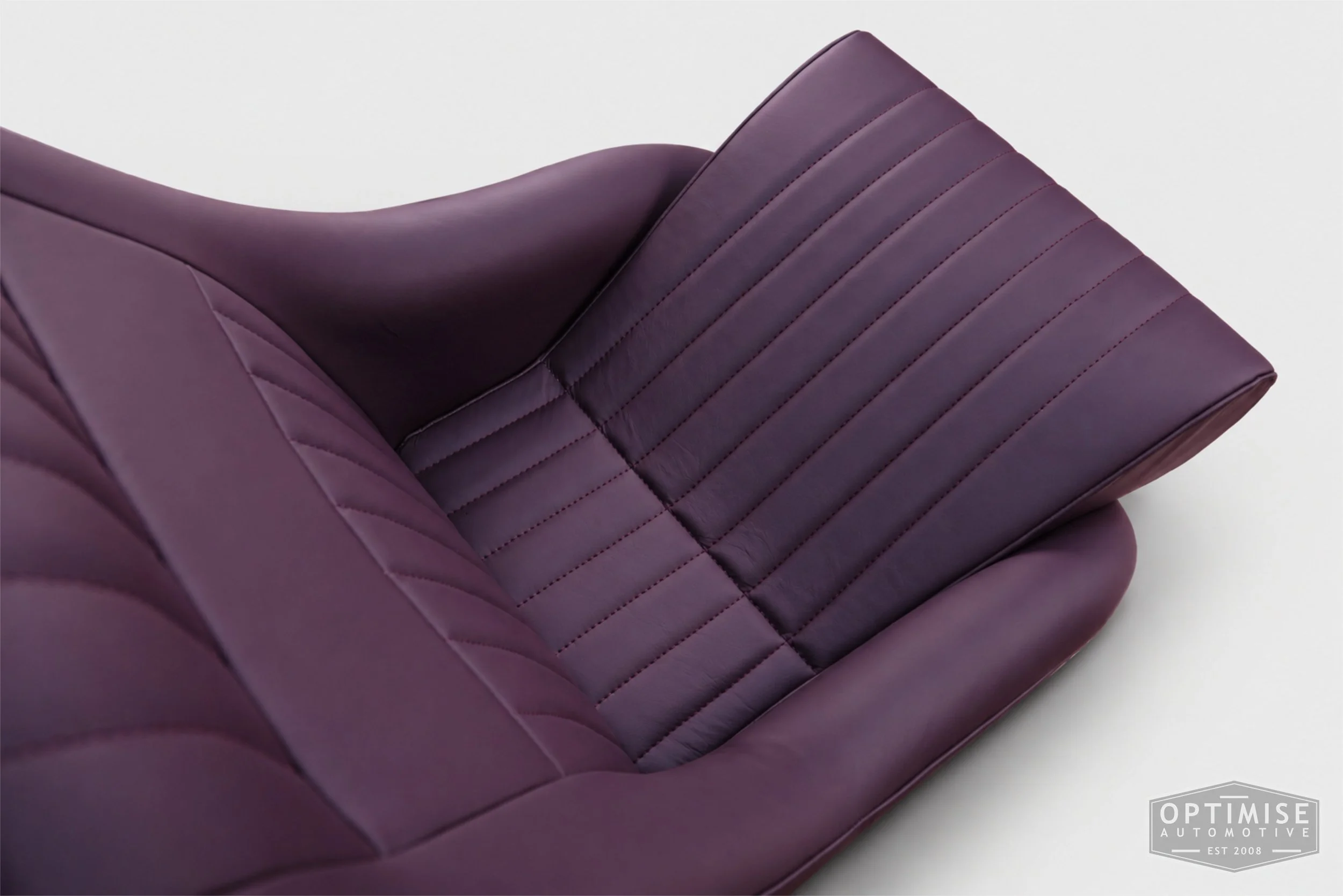 Classic Mini seat retrims featuring Cobra Monte Carlo front seats, trimmed in Caledonian aubergine leather.