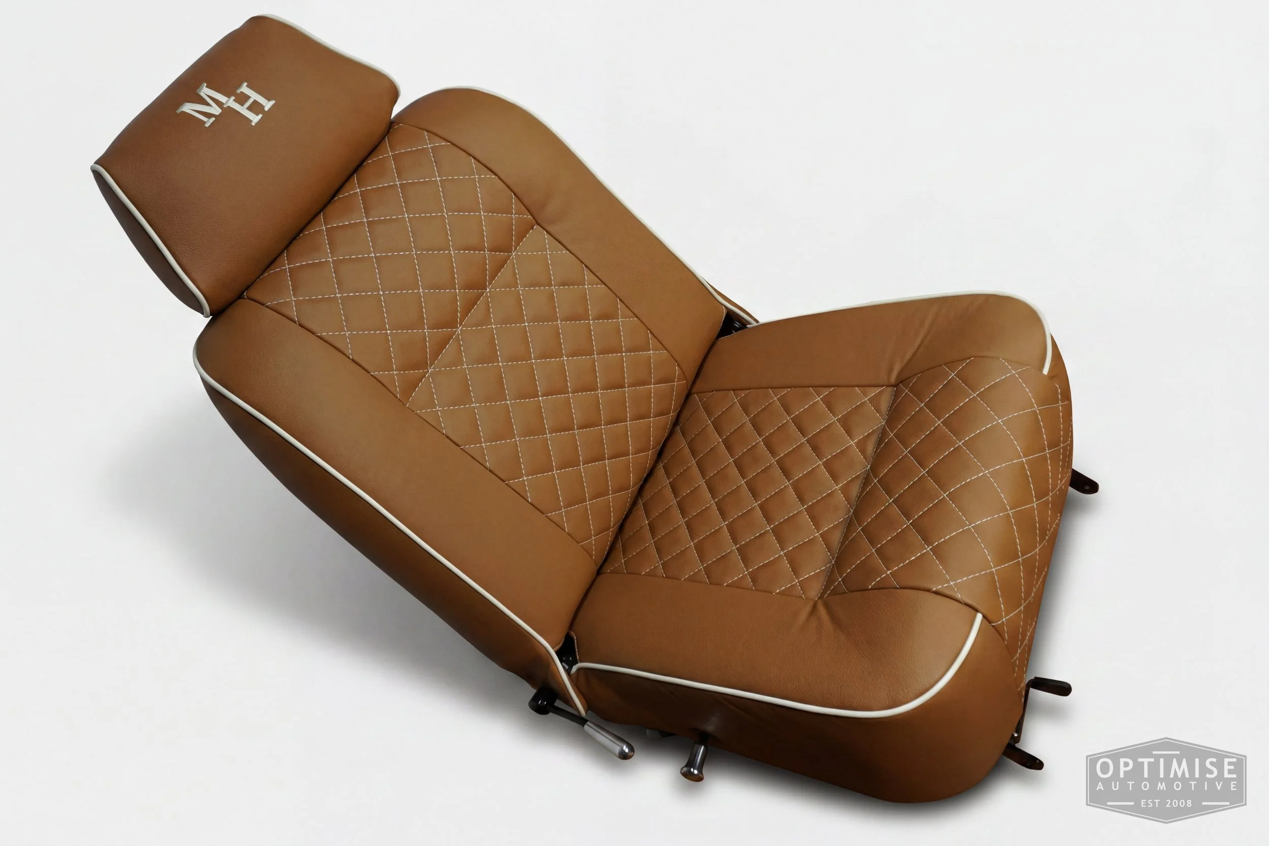Classic Mini single post headrest seat retrims, trimmed in light brown (tan) leatherette with cream piping and cream diamond stitching.