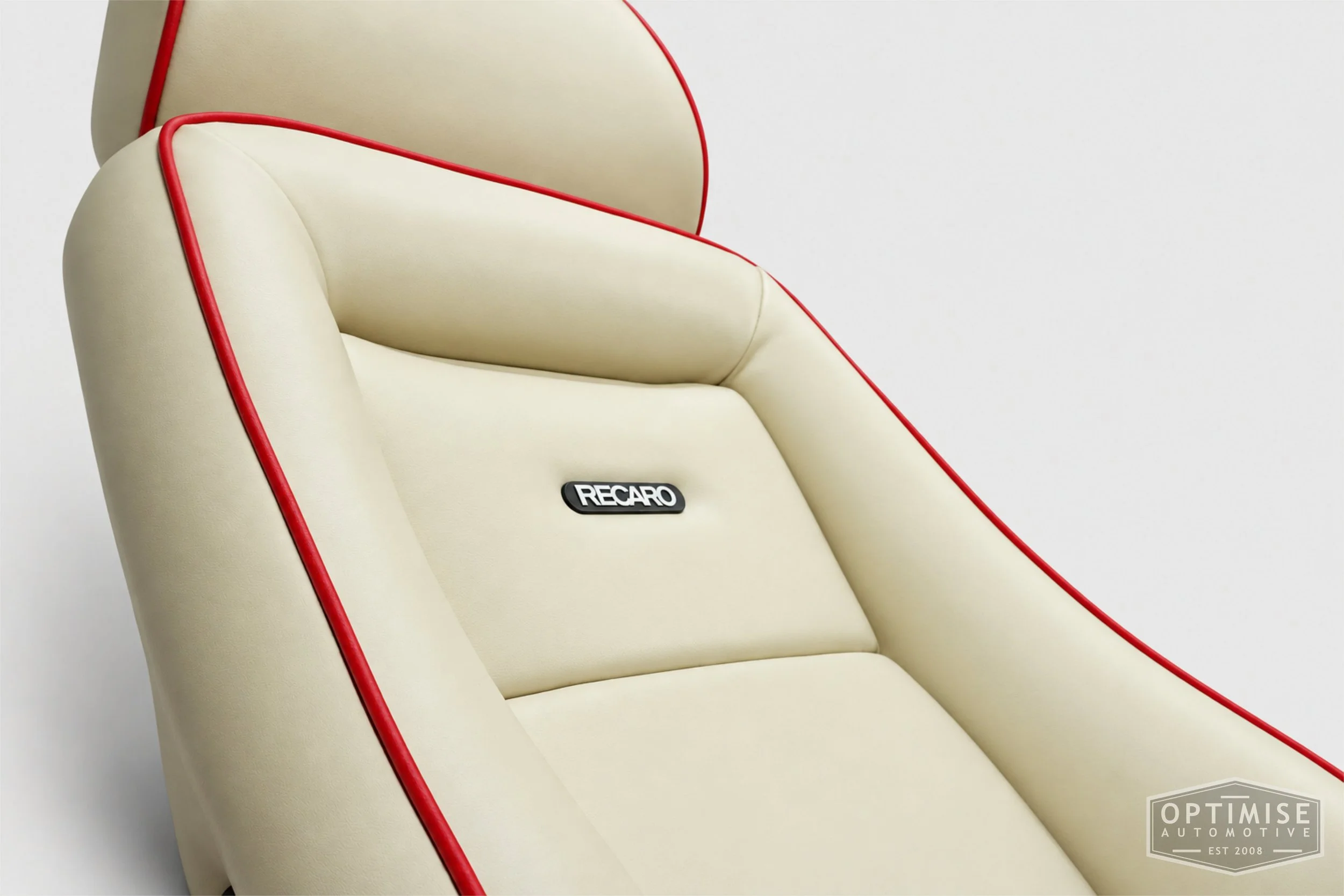 Classic Mini seat retrims featuring legendary RS Turbo Recaro front seats and a matching MK5 rear seat, trimmed in cream leatherette with red piping.