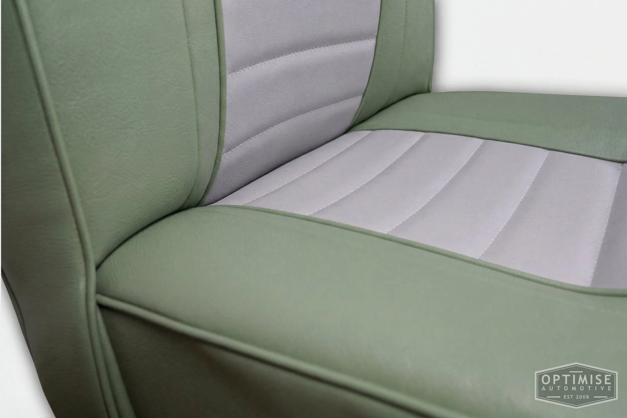 Classic Mini non-reclining seat retrims, trimmed in porcelain green and dove grey vinyl leatherette.