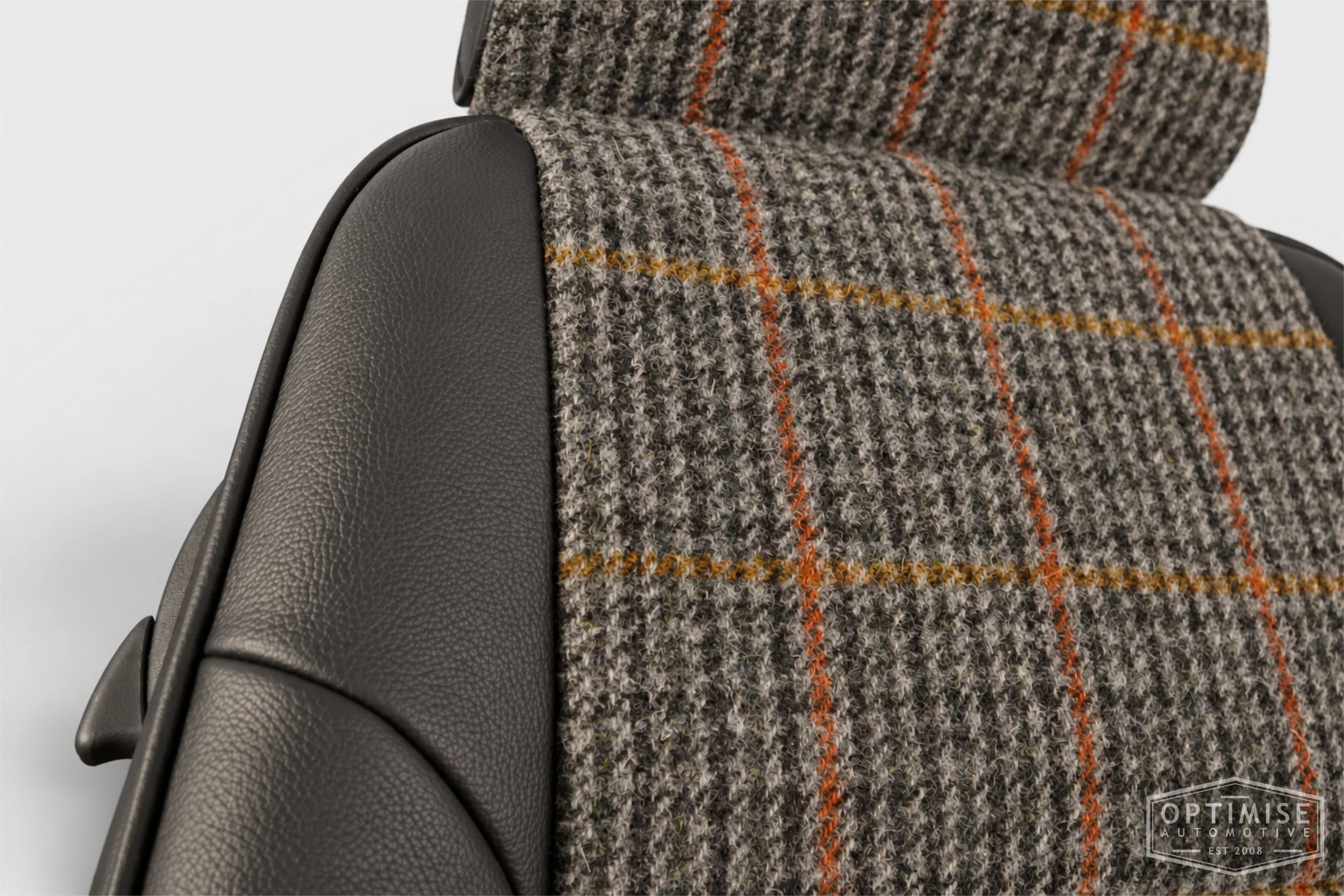 Classic Mini seat retrims featuring original MPi front seats and a matching rear seat, trimmed in Harris Tweed HO57 and black Crest Shelly leather.