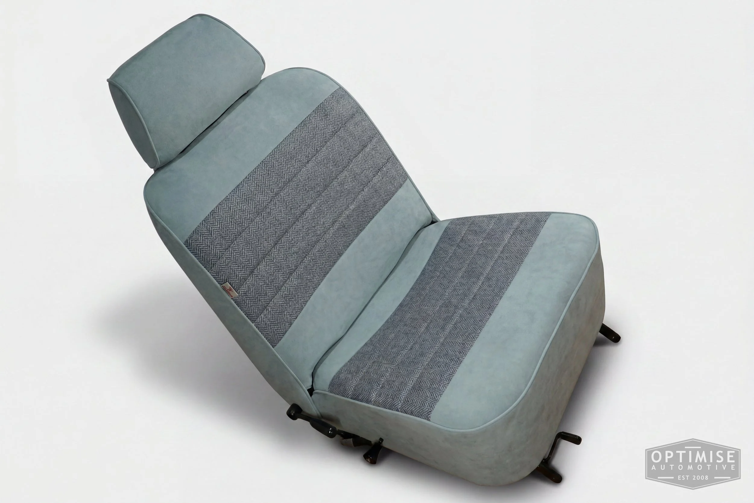 Classic Mini single post headrest seat retrims, trimmed in light blue Alcantara and Harris Tweed HB108.