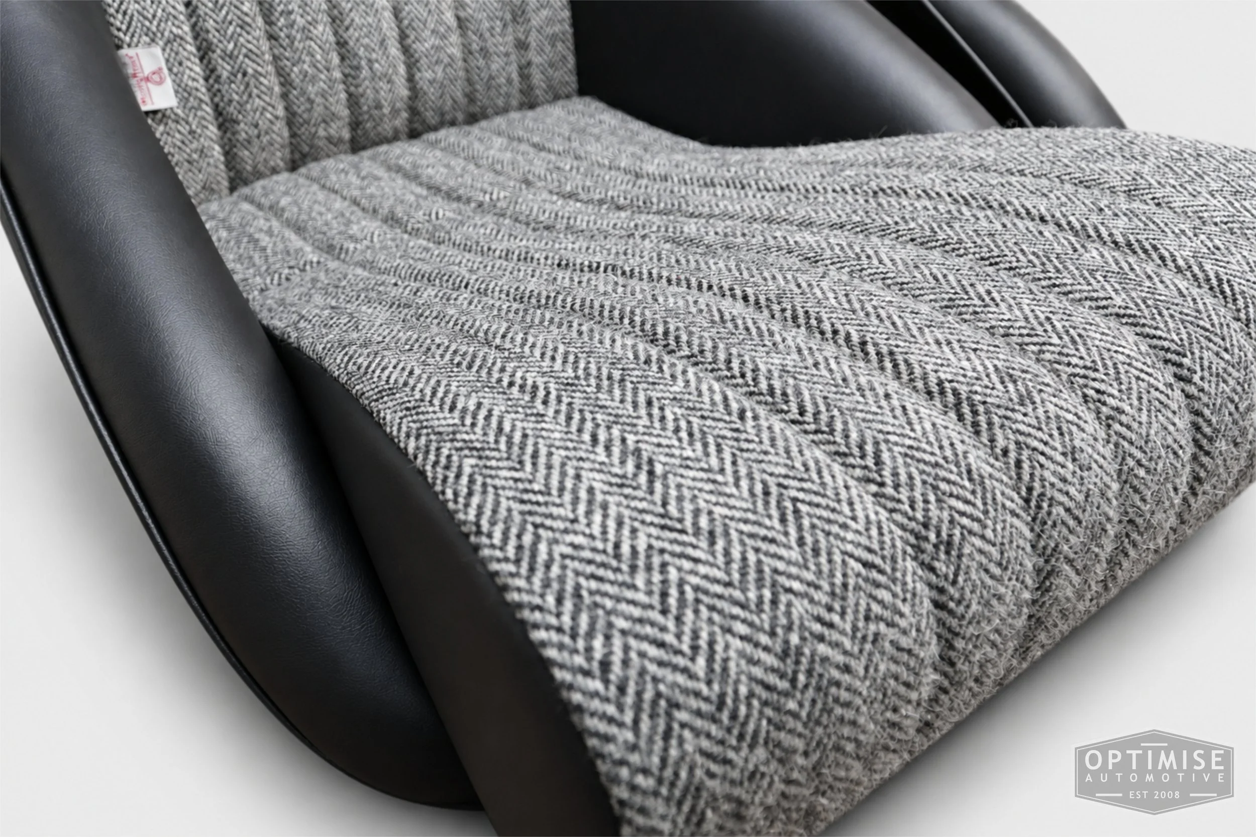 Classic Mini seat retrims featuring Cobra Monte Carlo front seats, trimmed in black leatherette and Harris Tweed HB1.