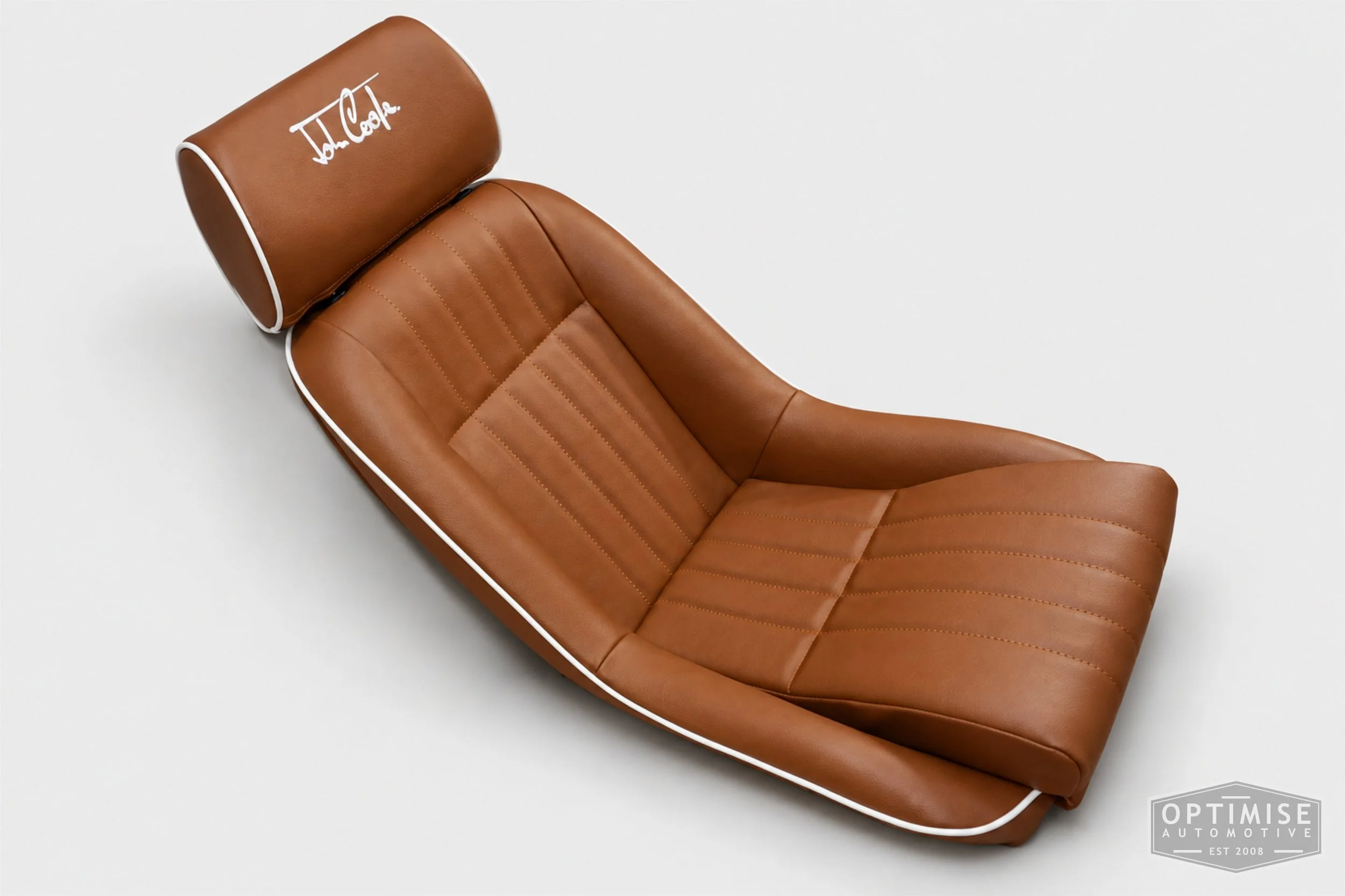 Classic Mini seat retrims featuring Cobra Cub front seats, trimmed in tan leatherette with white piping and John Cooper signature embroidery on the headrests.