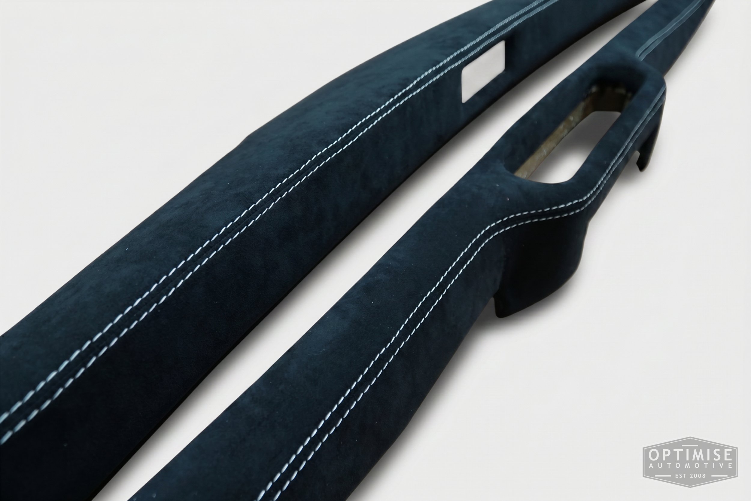 Classic Mini dash rail retrims, trimmed in black Alcantara with off-white stitching.