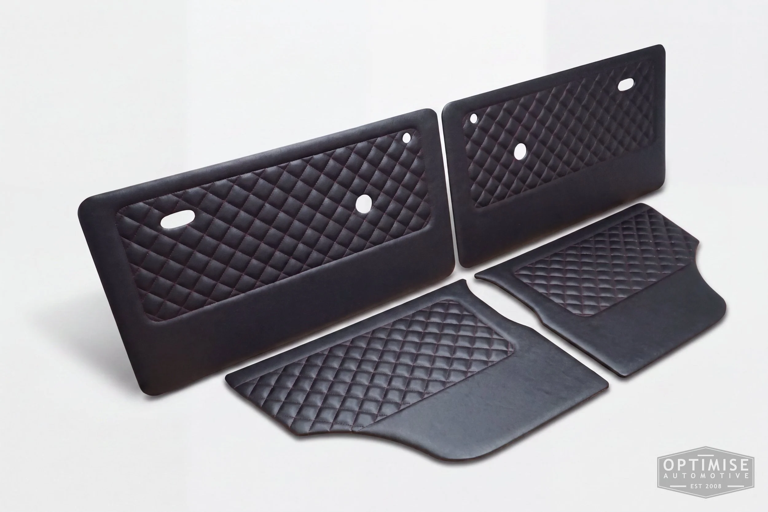 Classic Mini door cards, trimmed in black vinyl leatherette with a dark red diamond stitched featured panel.