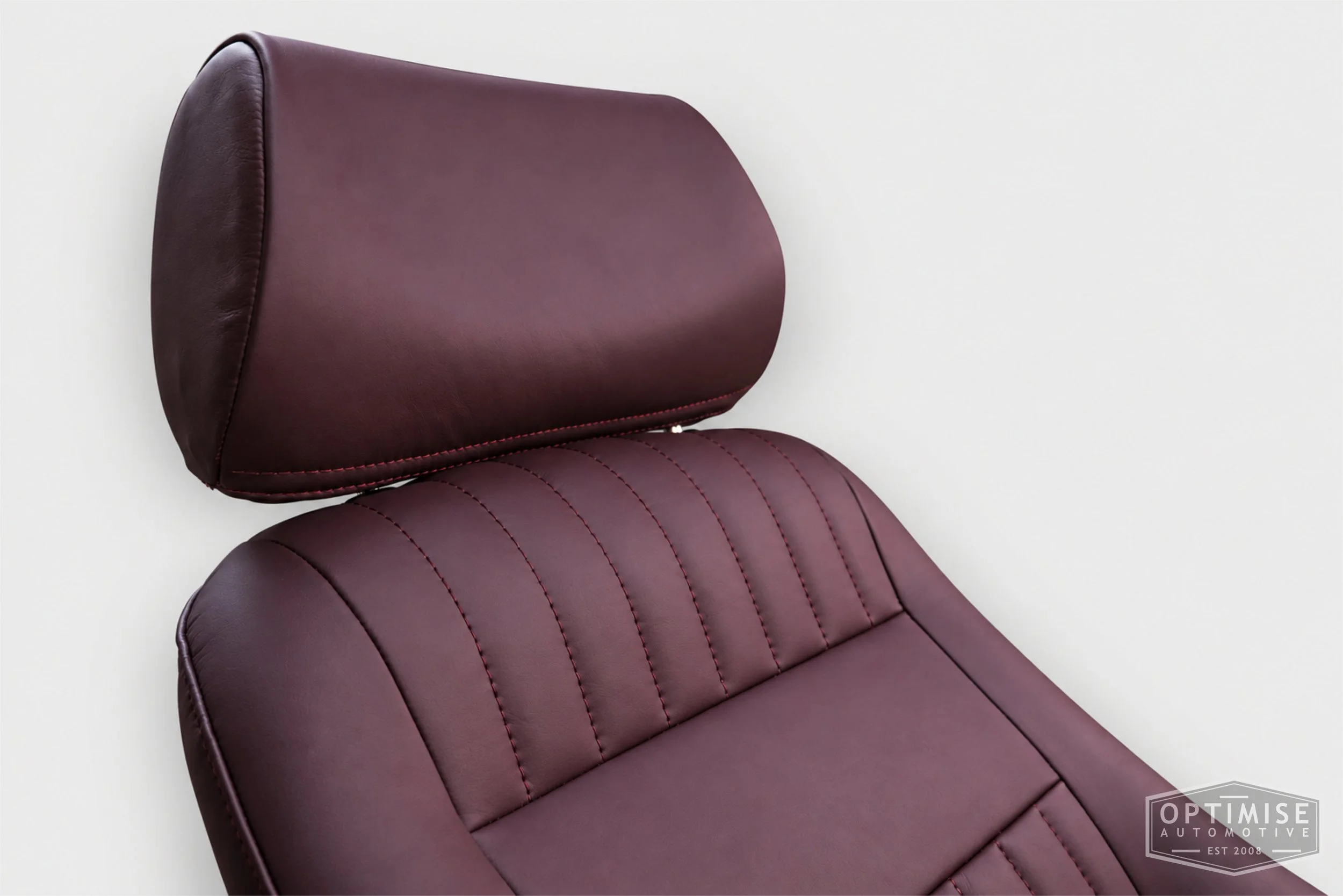 Classic Mini seat retrims featuring Cobra Monte Carlo front seats, trimmed in Caledonian aubergine leather.