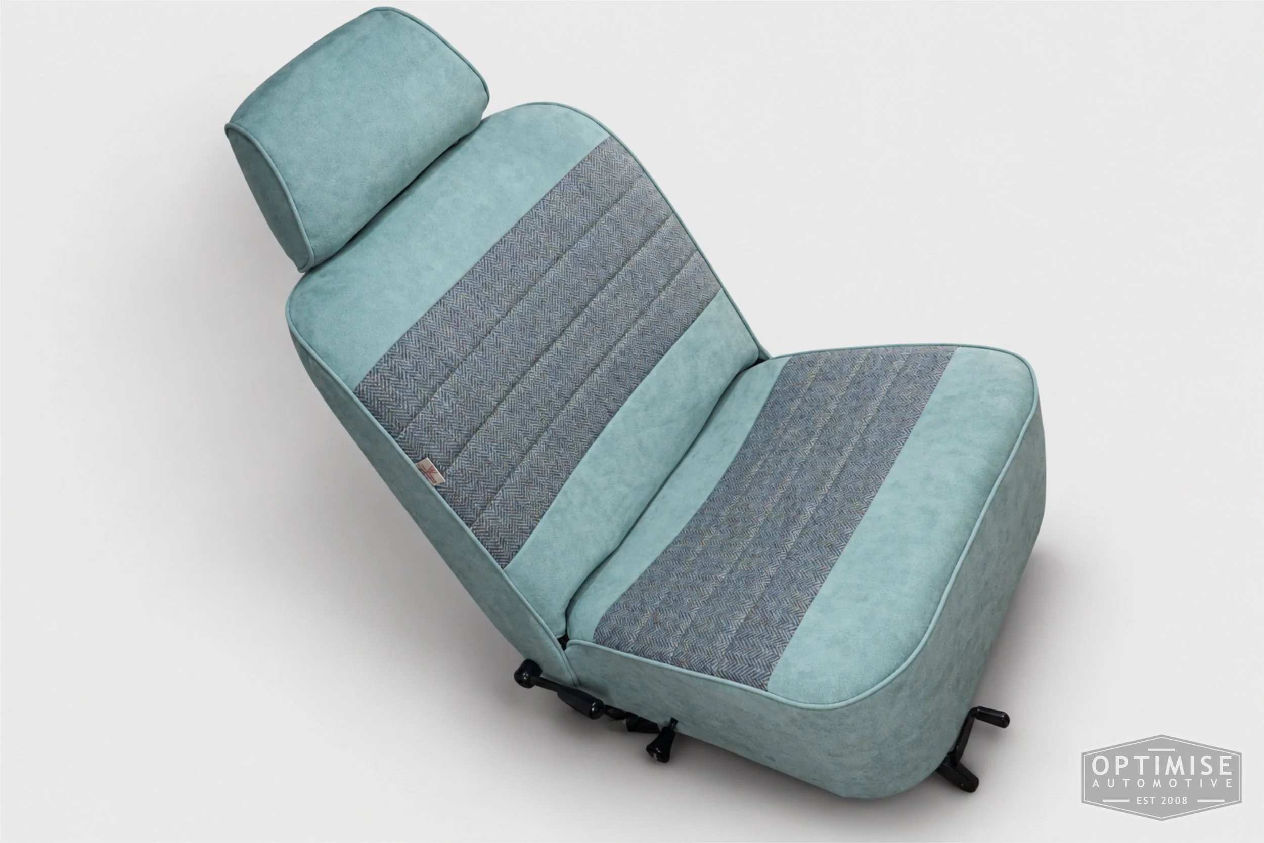 Classic Mini seat retrims featuring original single-post headrest front seats and a matching MK4 rear seat, trimmed in light blue Alcantara and Harris Tweed HB108.