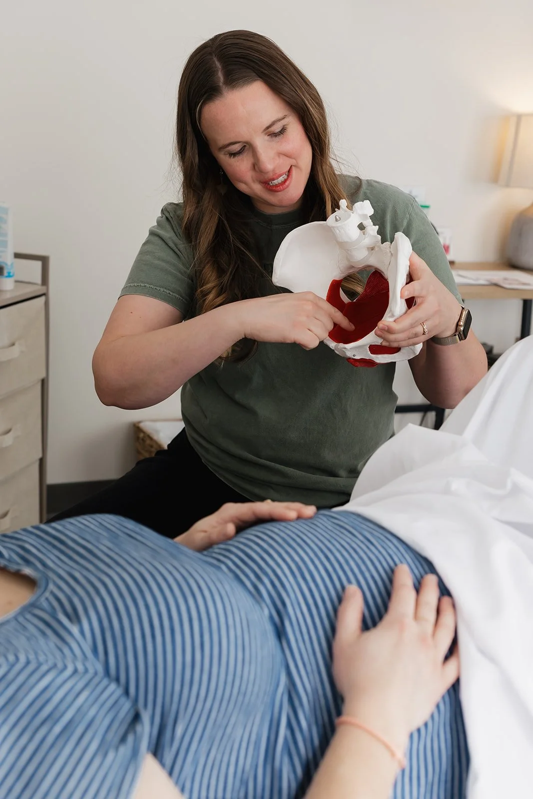 Pelvic health physical therapist helping pregnant woman with her pelvic floor in Columbia, MO