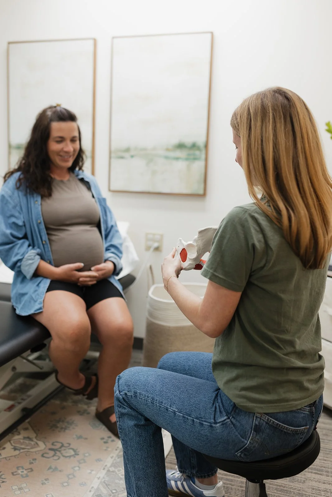 Dr. Hayley Stiers, pelvic floor physical therapist, educating a pregnant woman on pelvic floor physical therapy