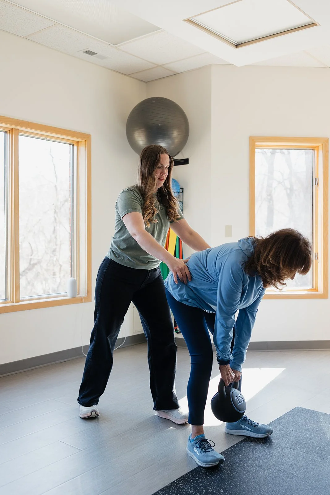 Older adult female athlete strength training with physical therapist in Columbia, MO