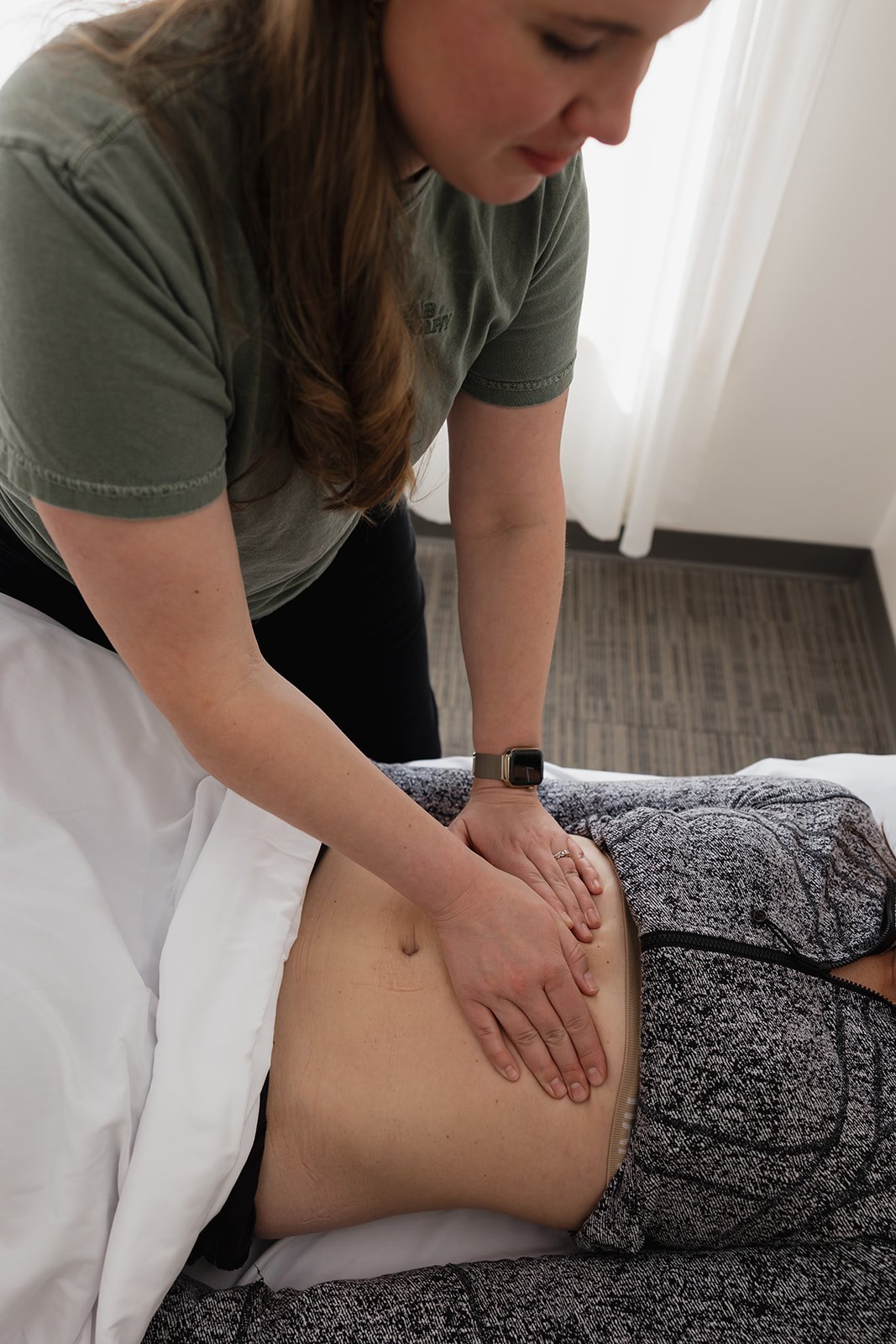 Pelvic health physical therapist working on abdominal wall and core strength with pelvic floor patient