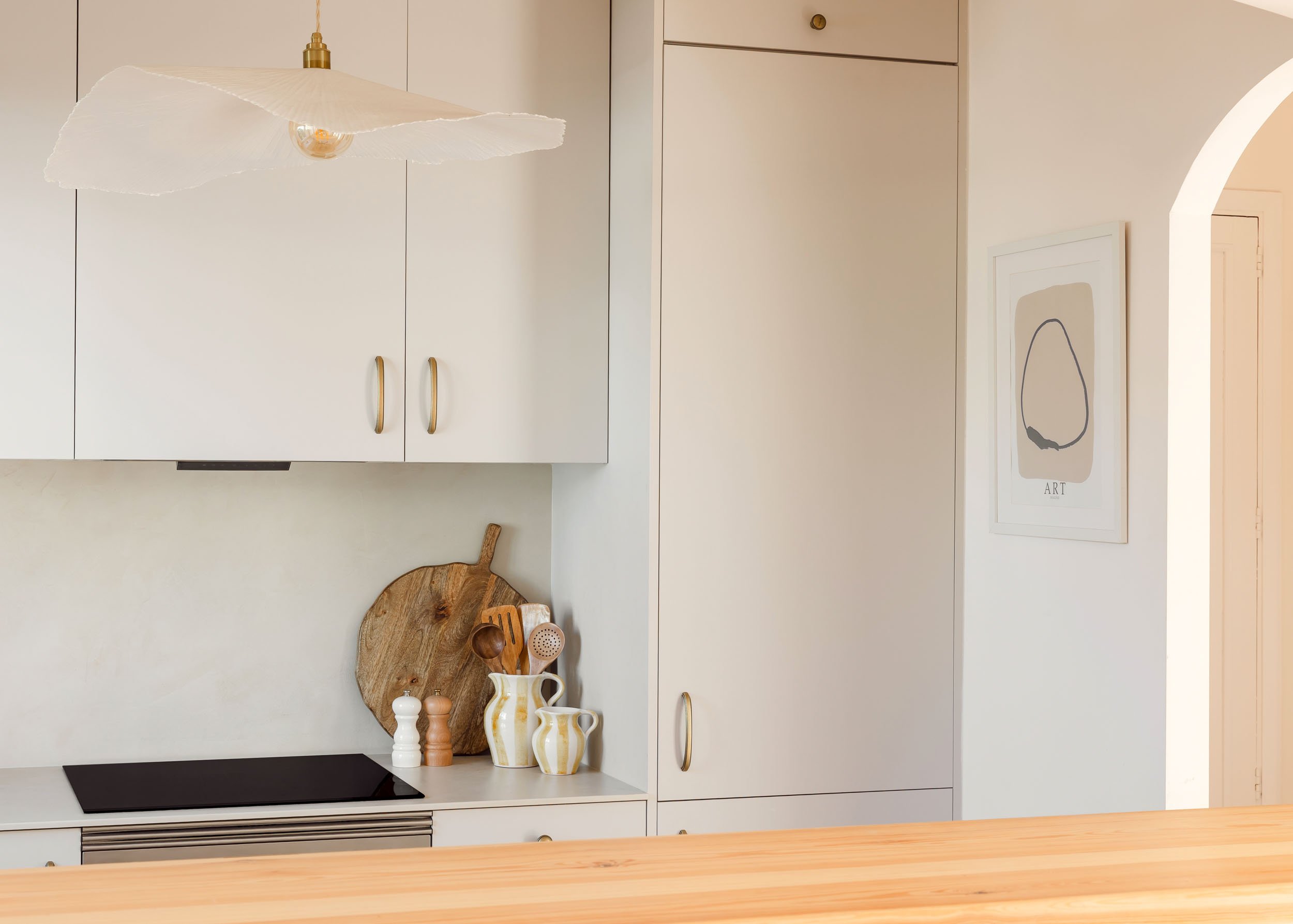 Minimal kitchen corner with light cabinetry and ceramic details