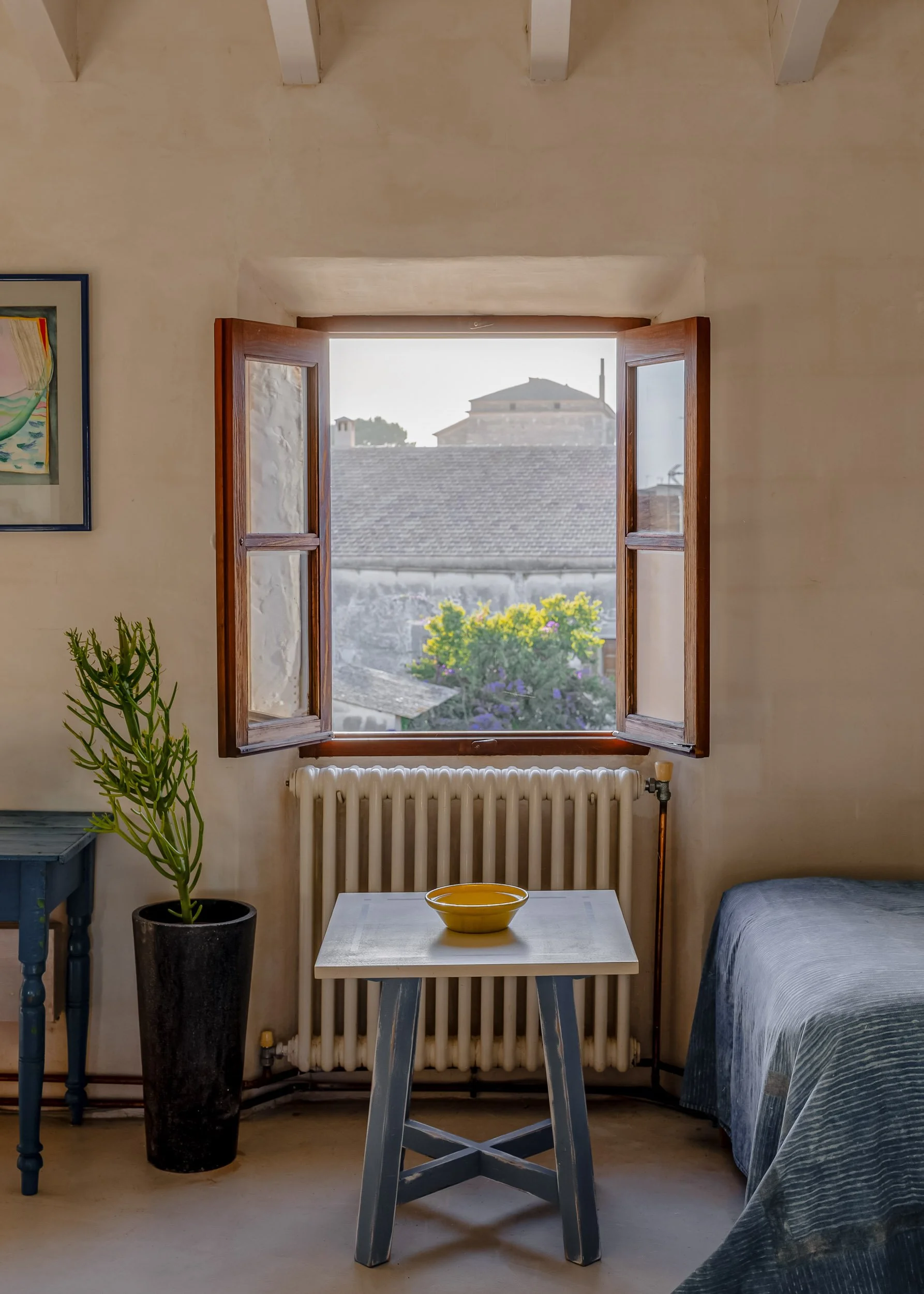 Bedroom corner with open window and traditional Mediterranean details