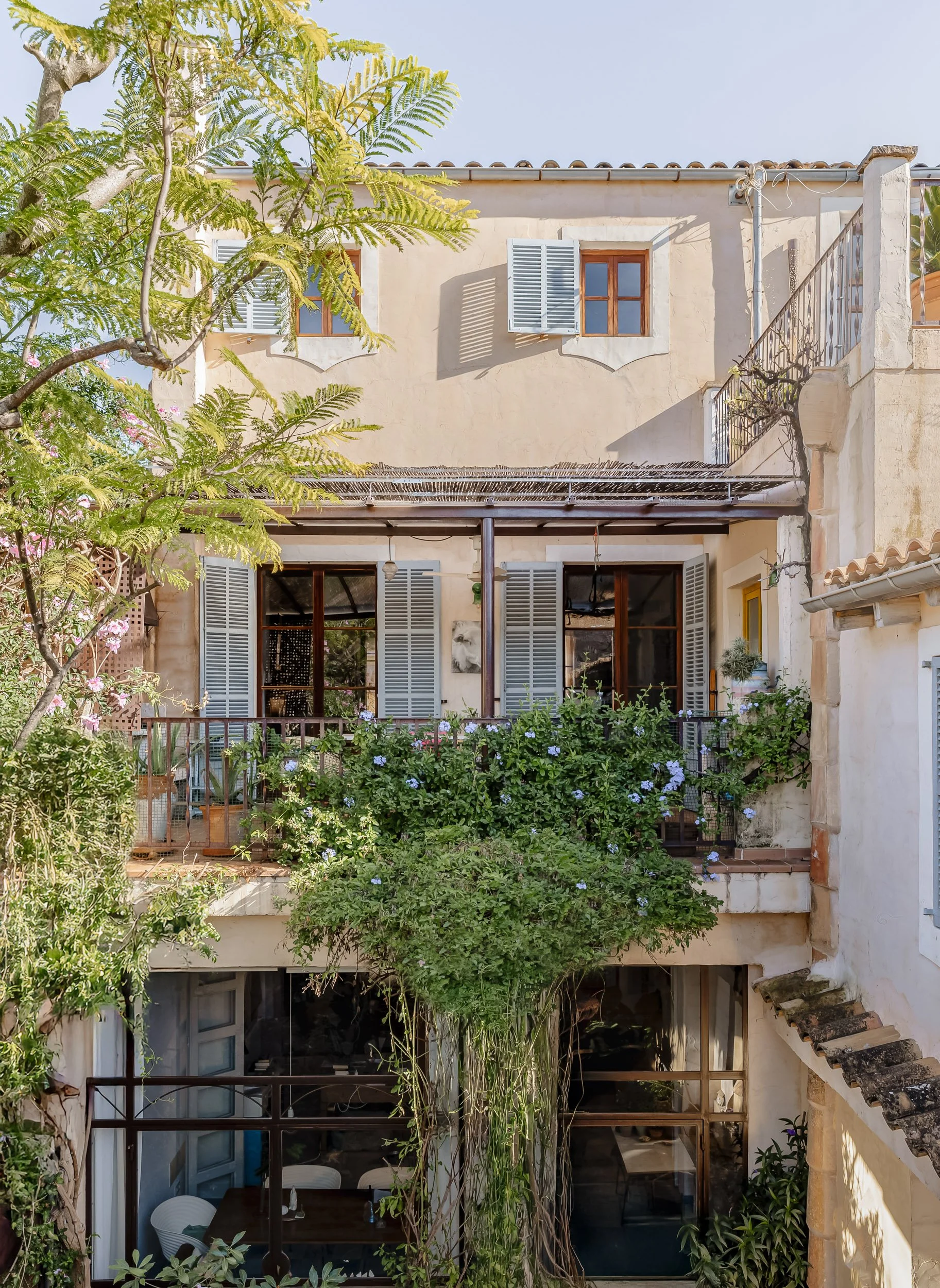 Traditional courtyard building with greenery and layered balconies