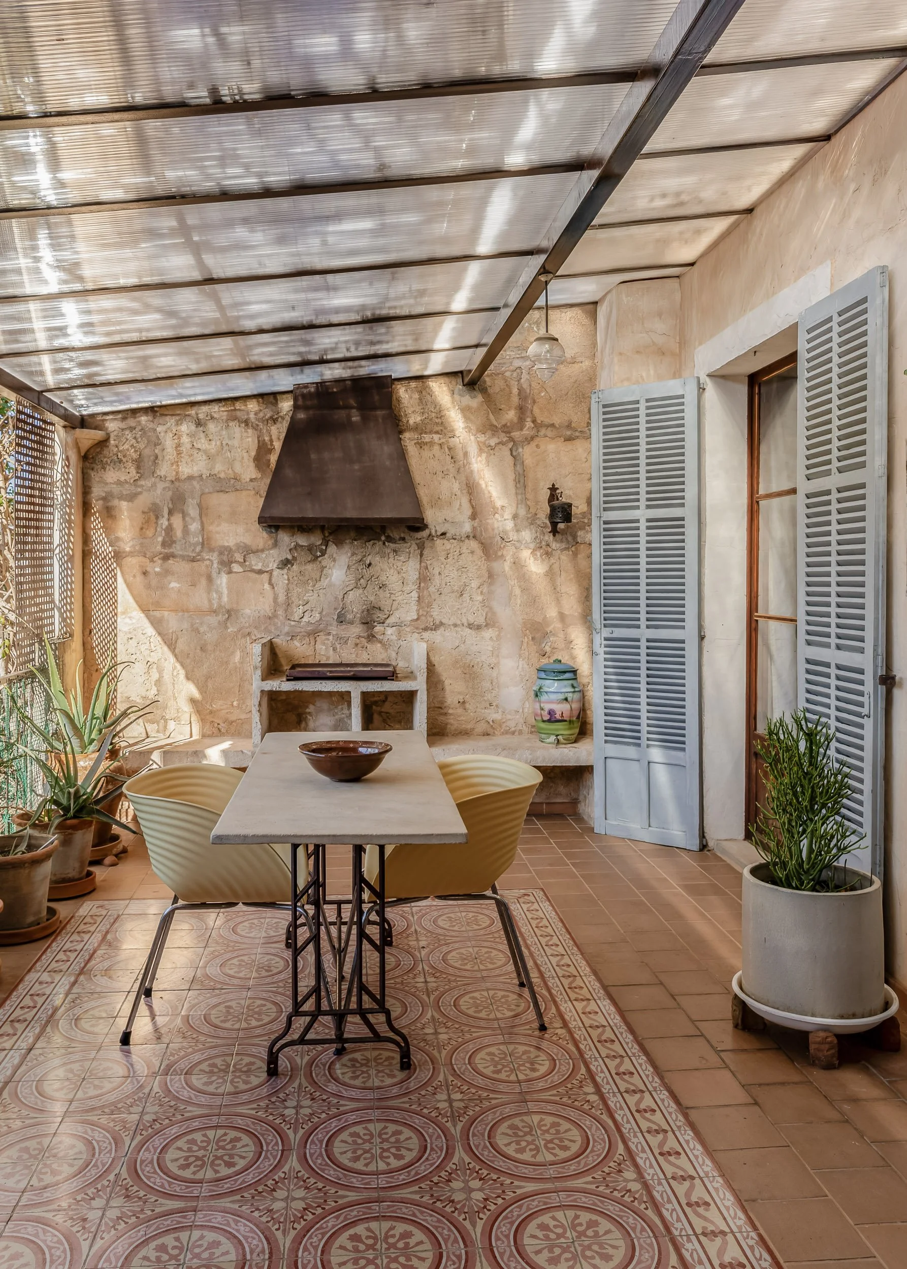 Outdoor dining area with stone walls and Mediterranean textures