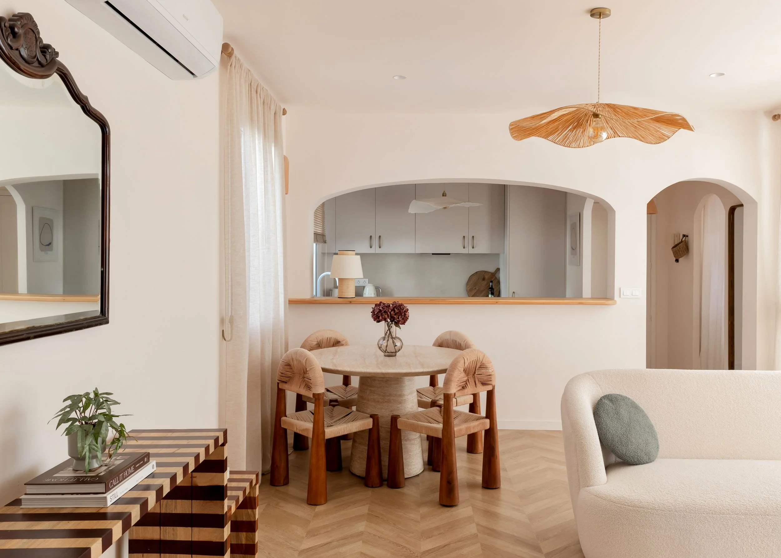 Open dining space with arched opening and neutral palette