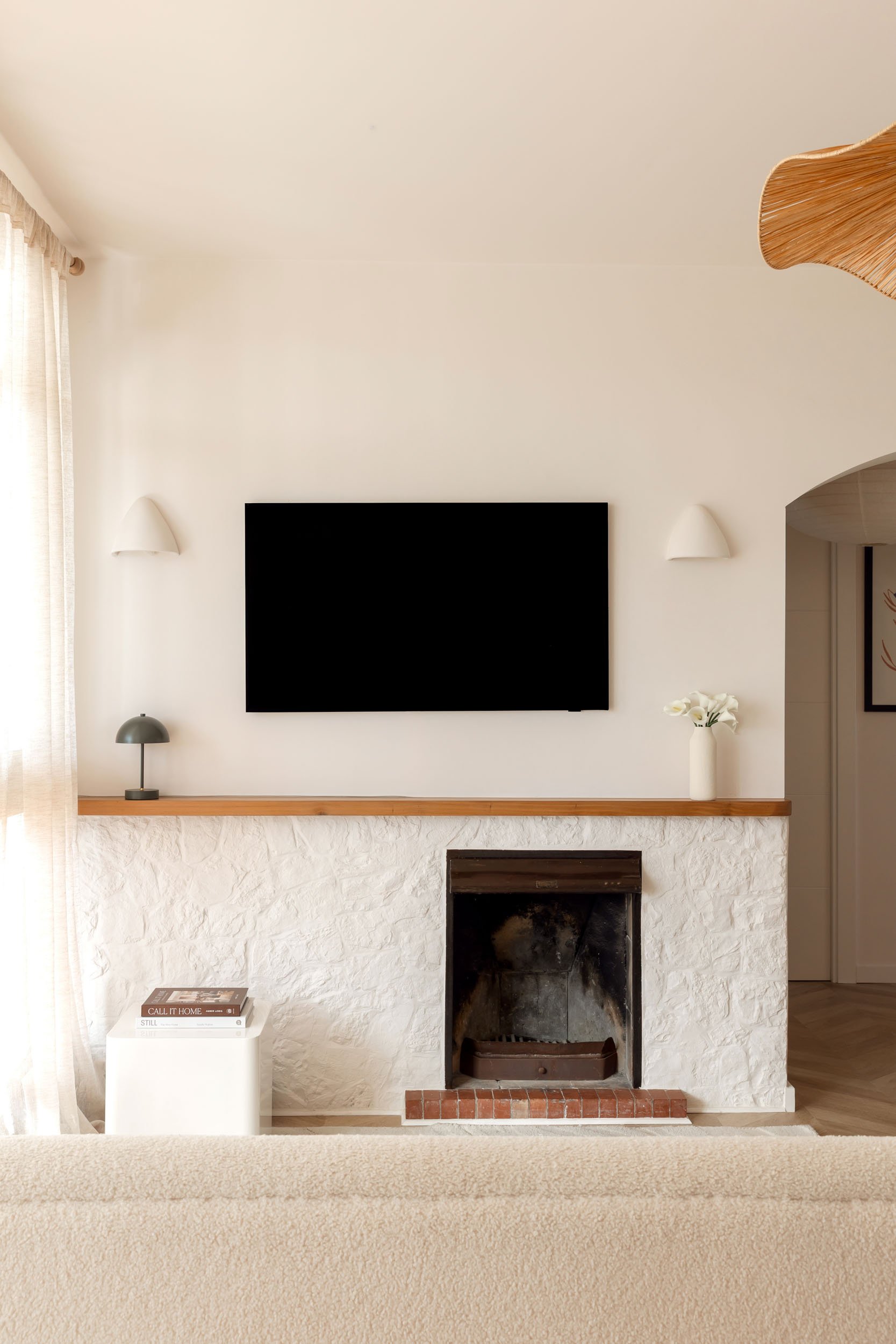 Living room fireplace with textured plaster and soft light