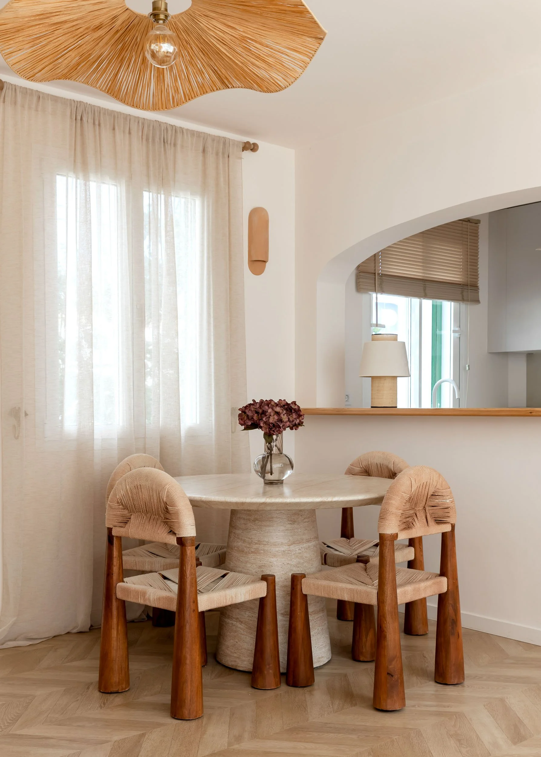 Dining corner with natural wood table and woven chairs