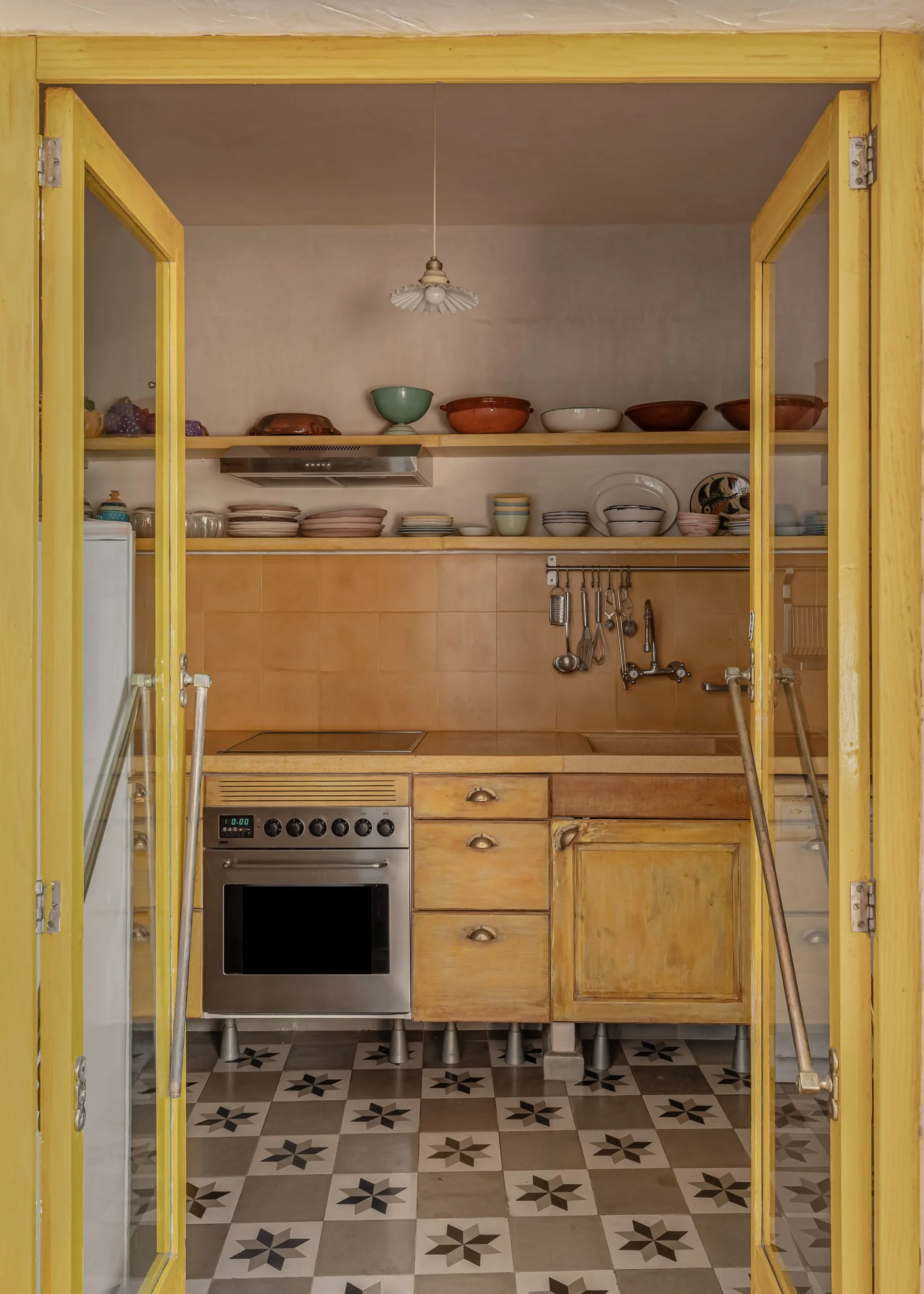 Rustic kitchen with yellow doors and warm wooden cabinetry